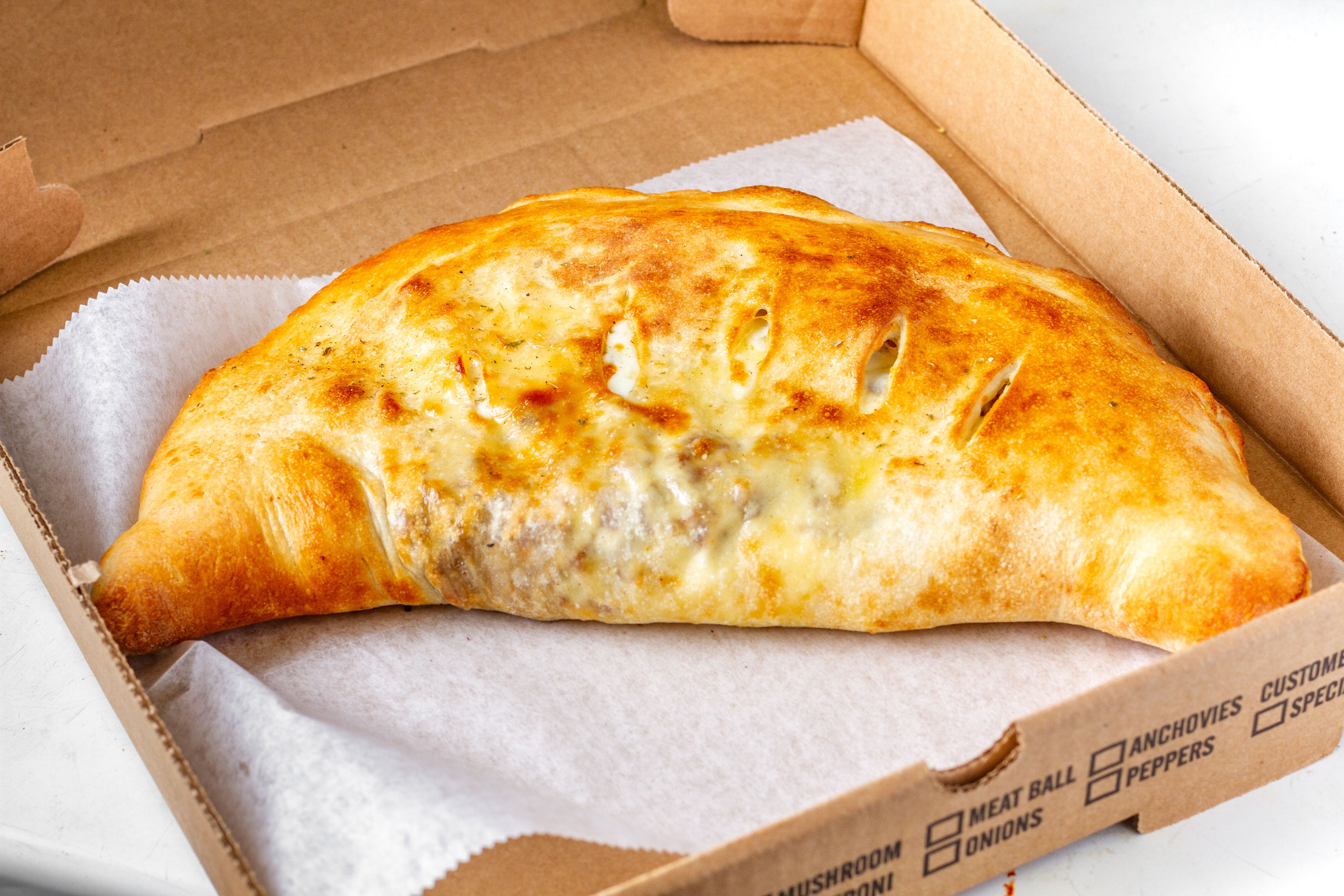Order Ground Beef Stromboli - Stromboli food online from Mikie's Pizza & Subs store, Baltimore on bringmethat.com