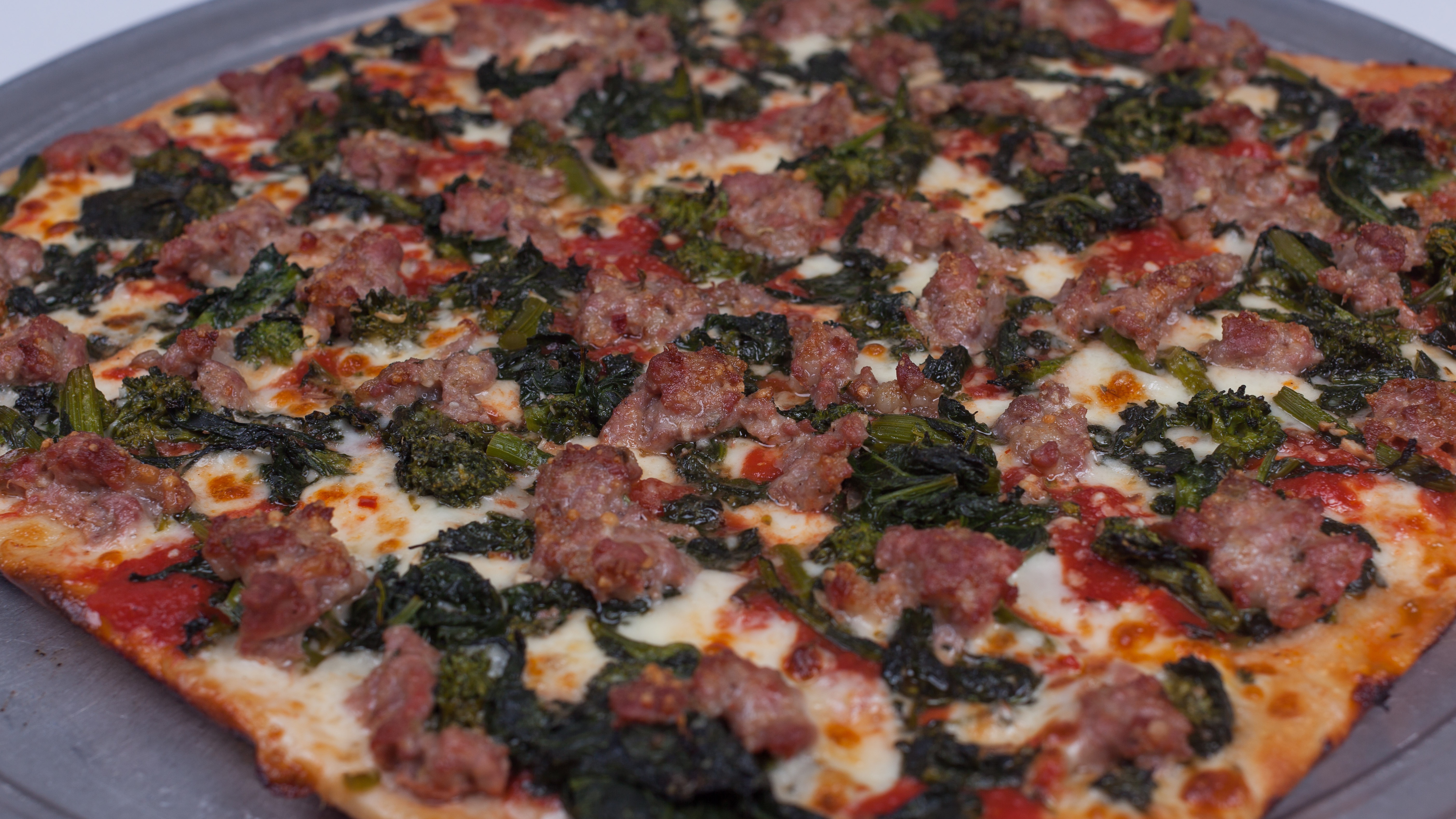 Order Grandma Broccoli Rabe & Sausage Pie food online from Umberto's Pizzeria store, New Hyde Park on bringmethat.com