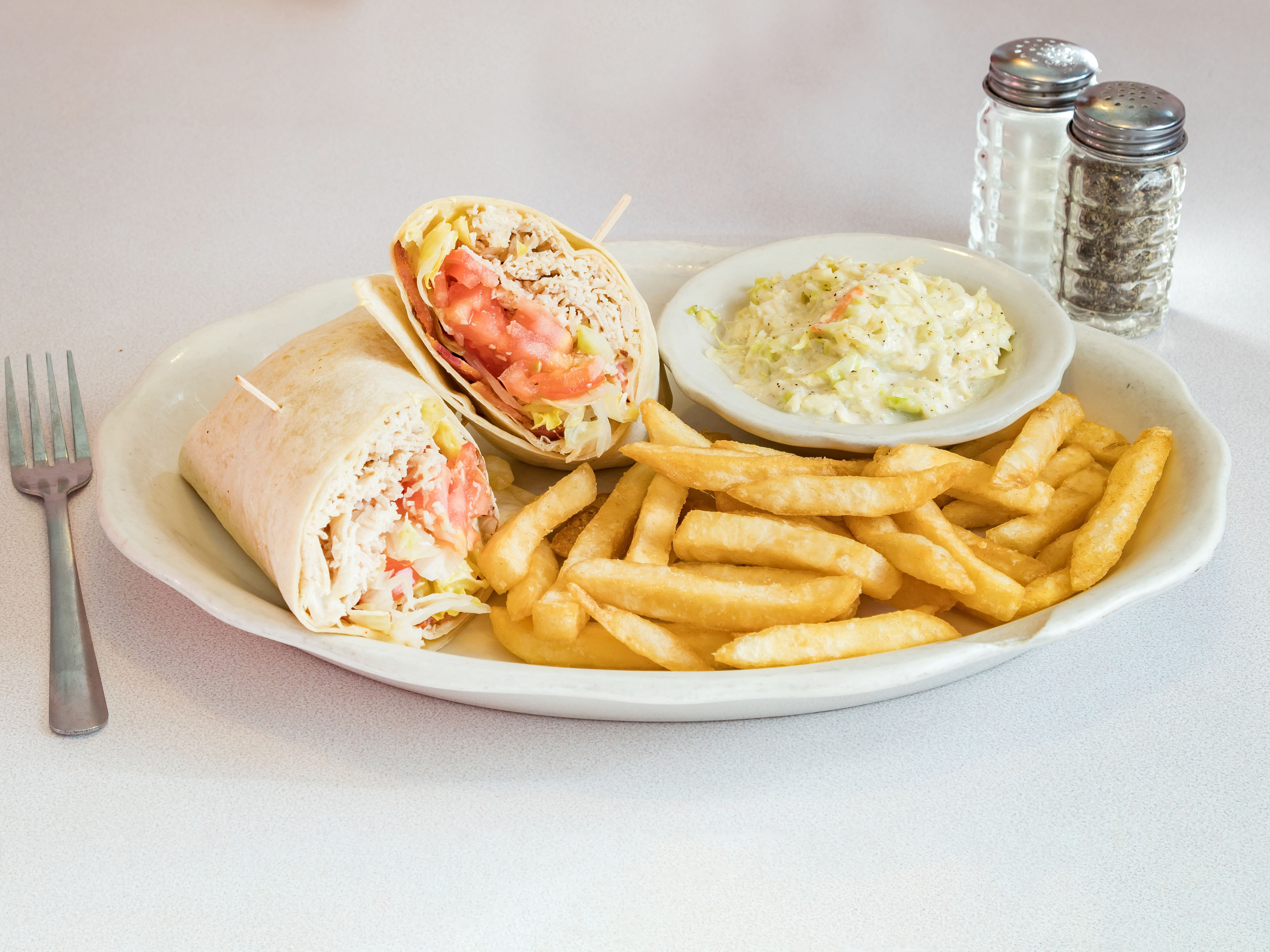 Order Athenian Turkey Club Wrap With fries and coleslaw food online from Athenian Restaurant store, Philadelphia on bringmethat.com