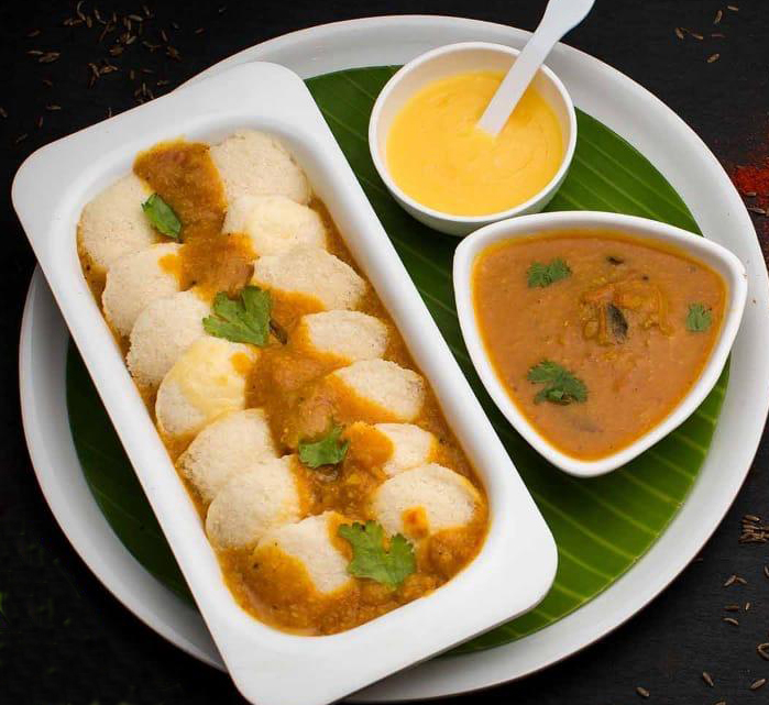 Order 14 Pieces Mini Ghee Idly food online from Saravanaa Bhavan store, Princeton Junction on bringmethat.com