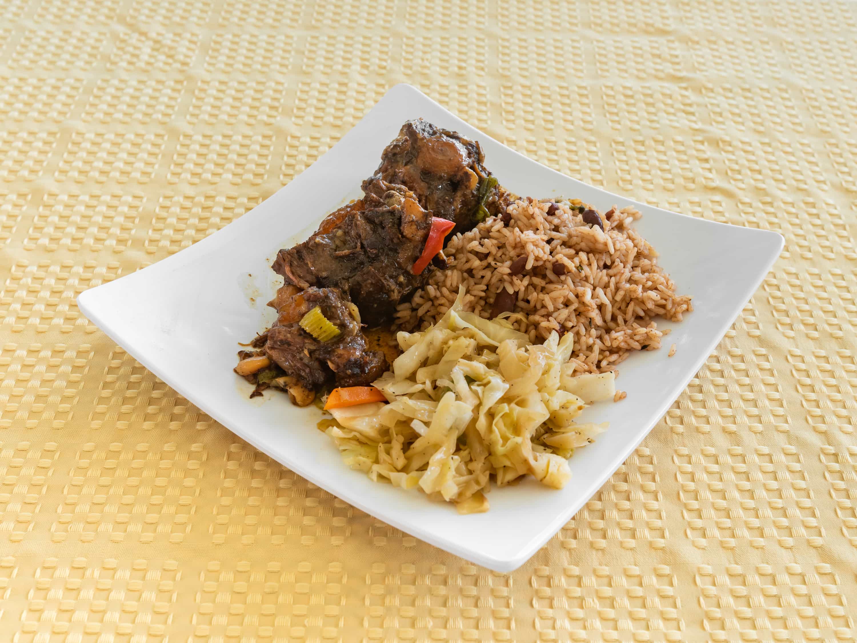 Order Oxtails includes rice & cabbage food online from Iwayne Caribbean Kitchen store, Manor on bringmethat.com