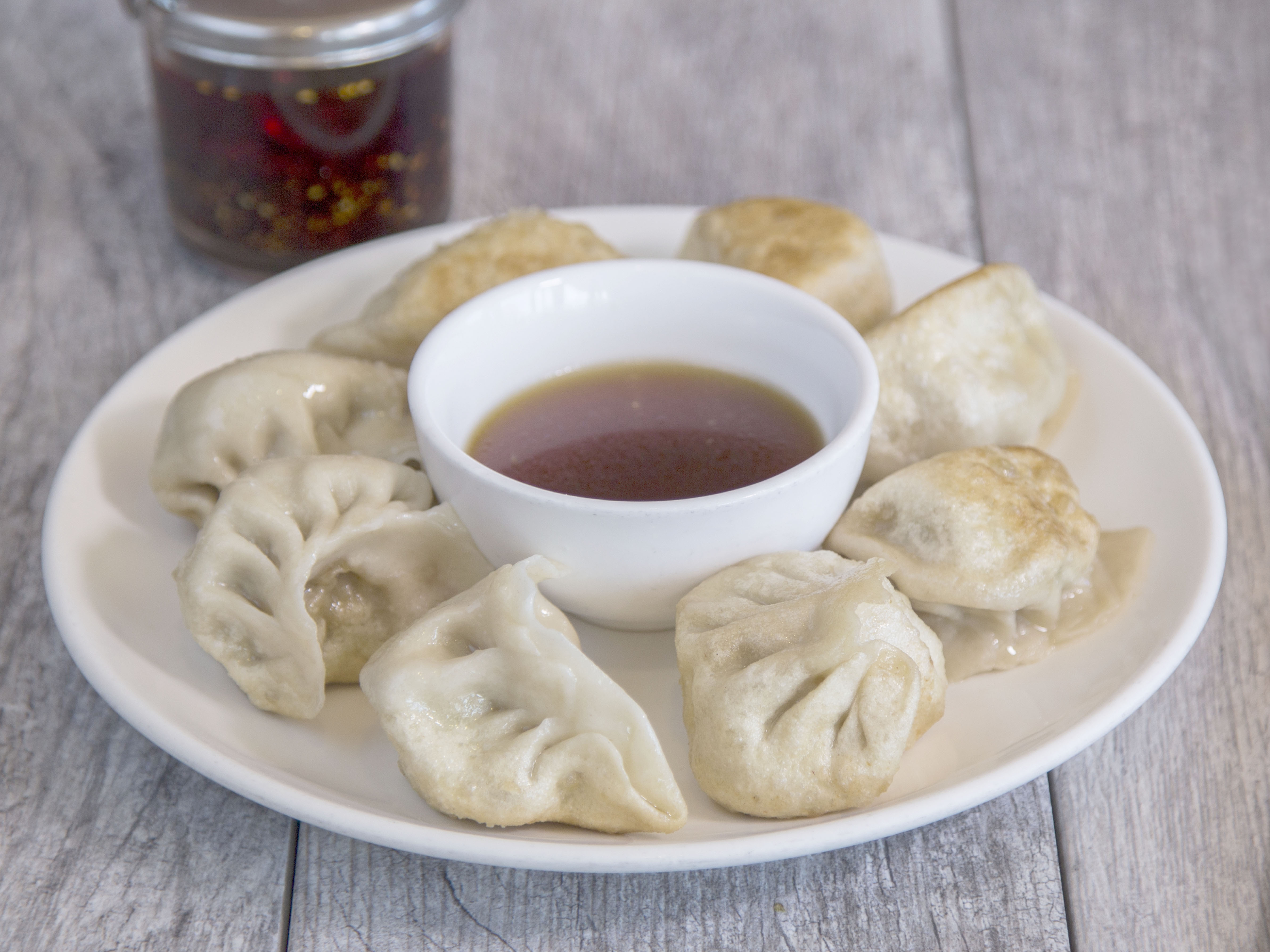 Order 5. 8 Pan Fried Dumplings food online from China Magic Noodle House store, Chandler on bringmethat.com