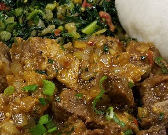 Order Goat curry with ugali and greens food online from Kilimanjaro Grill store, Minneapolis on bringmethat.com