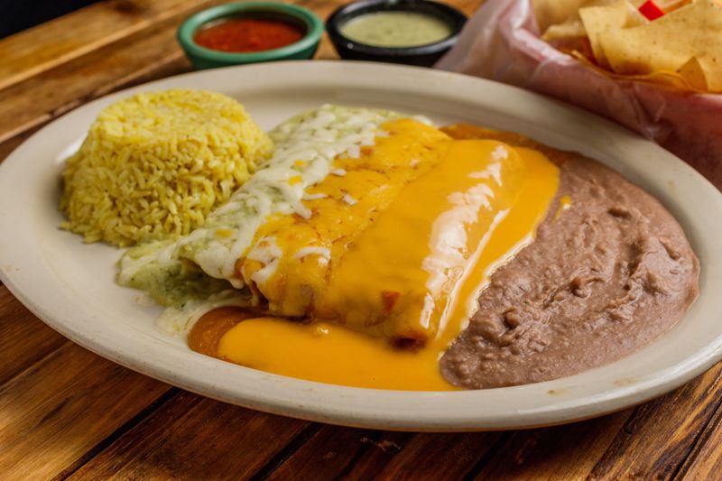 Order Cheese Enchilada (2) food online from Cilantros Mexican Restaurant store, Houston on bringmethat.com