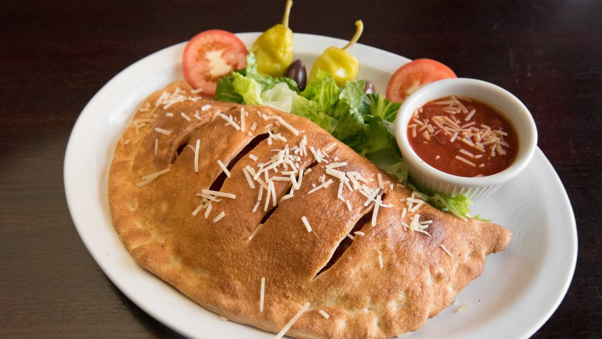 Order Meat Calzone food online from Soprano's Pizza & Pasta store, Seattle on bringmethat.com