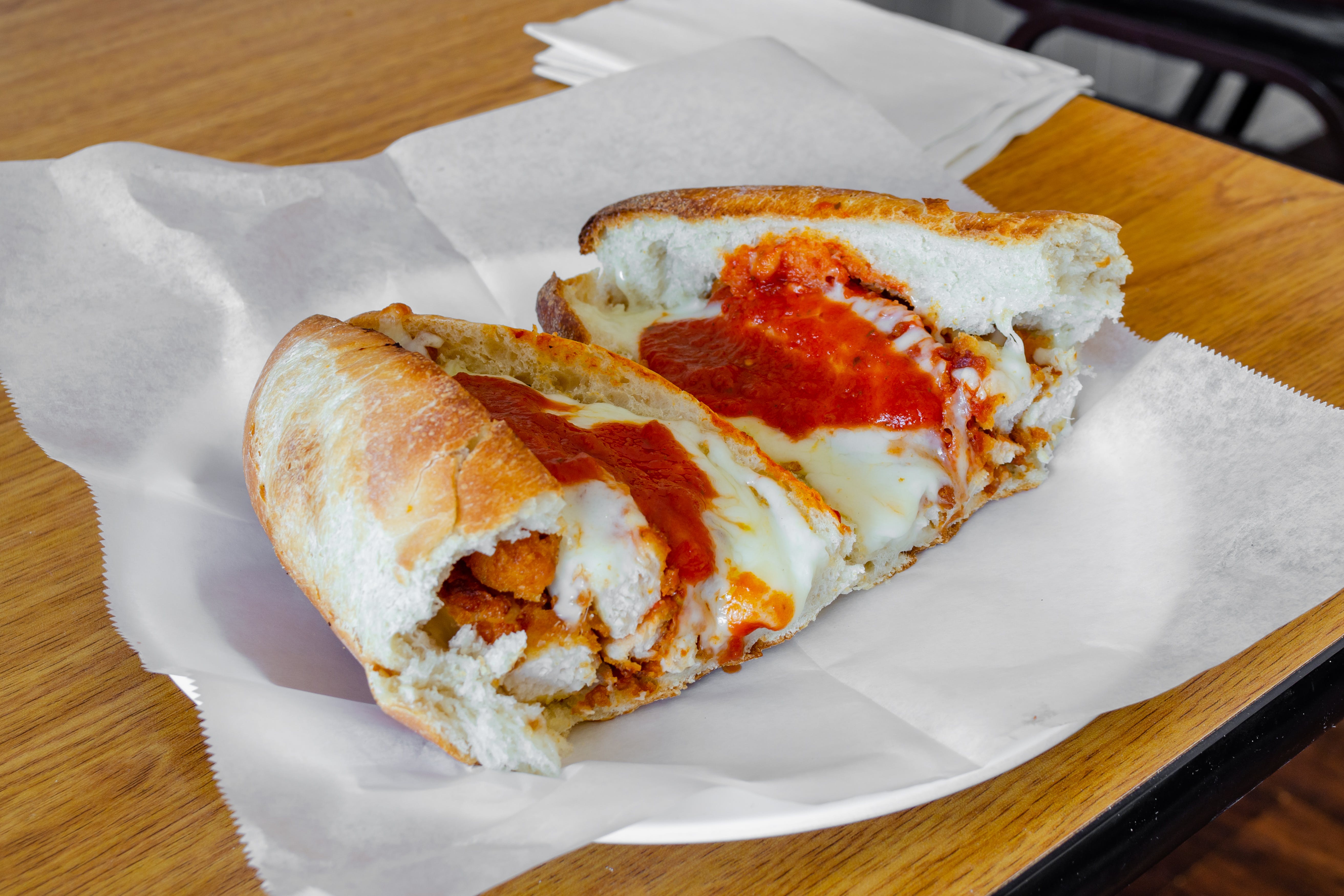 Order Chicken Cutlet Parmigiana Sandwich - 12" Roll food online from Panzini Pizzeria store, Sea Isle City on bringmethat.com