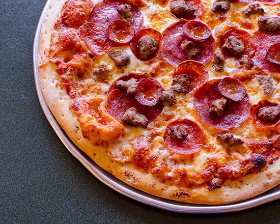 Order Montague’s All Meat Marvel Pizza - Italian sausage, pepperoni, salami and linguica on zesty red sauce. food online from Round Table Pizza store, South San Francisco on bringmethat.com