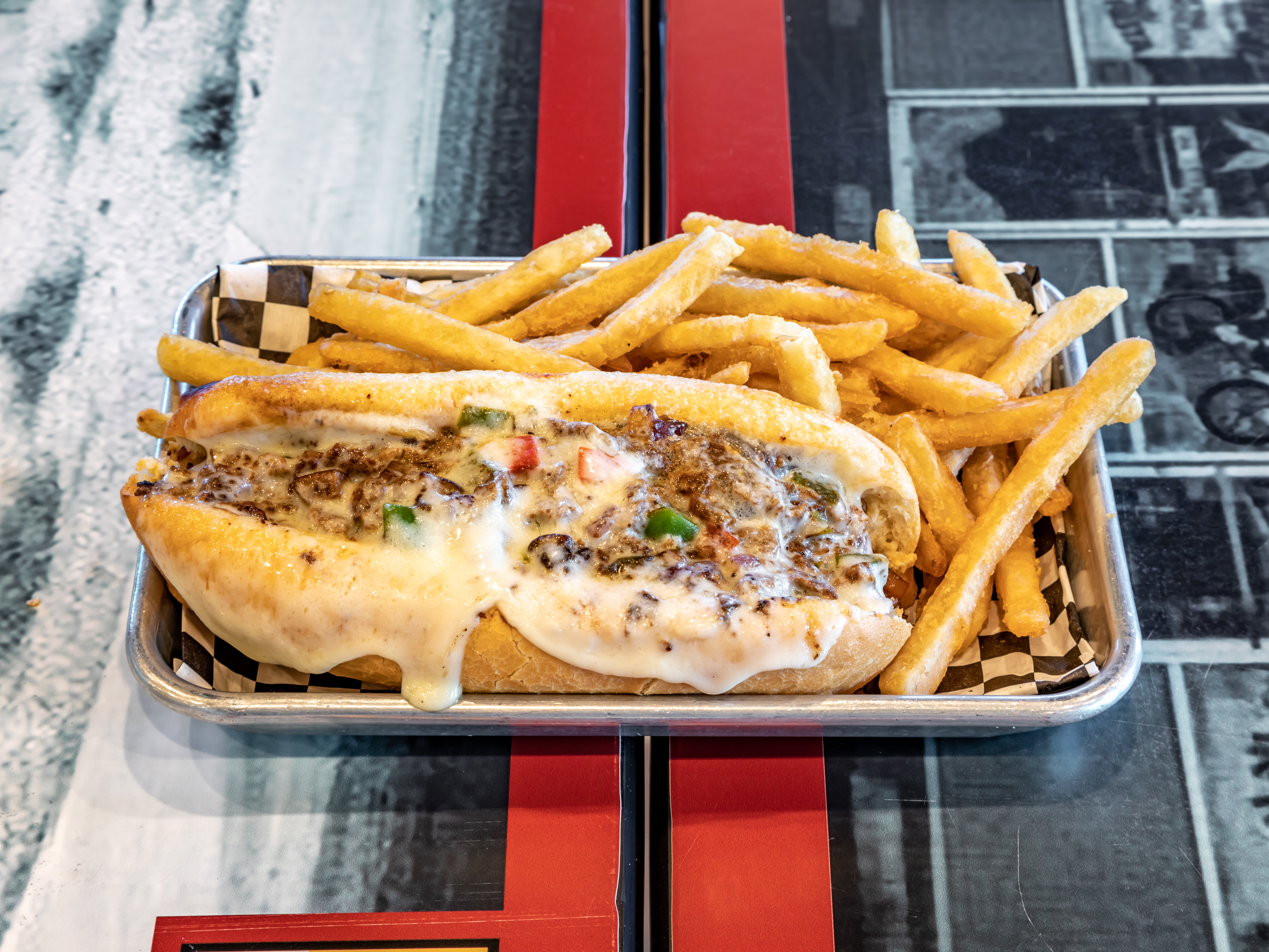 Order Philly Cheesesteak with Fries food online from The Hudson Eatery & Bar store, Tempe on bringmethat.com