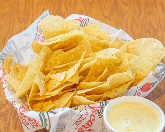 Order Queso and Chips (8 oz) food online from Oscar's Taco Shop store, Smyrna on bringmethat.com