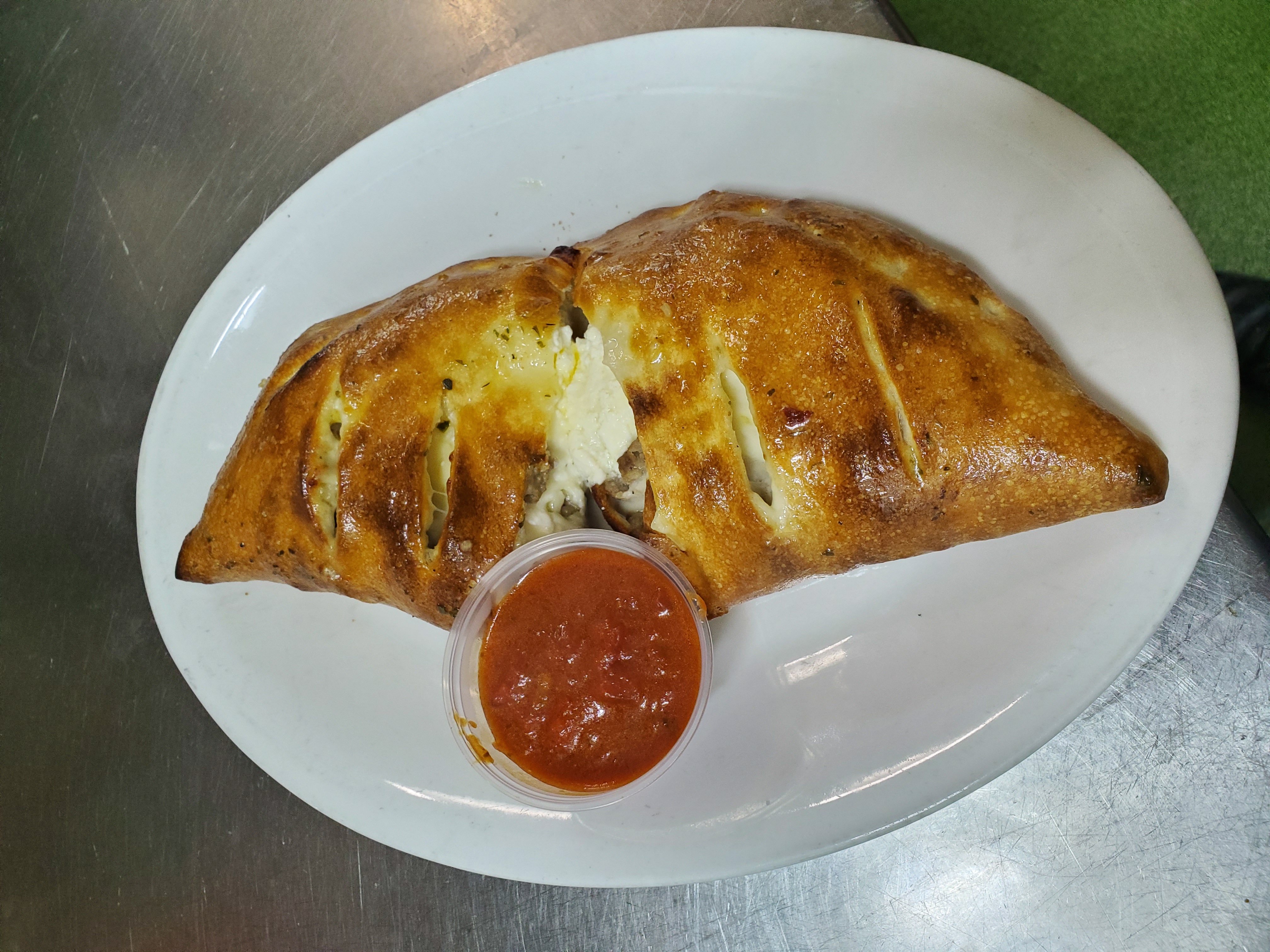 Order Regular Calzone with Pepperoni and Sausage food online from Pepes Pizza store, North Richland Hills on bringmethat.com