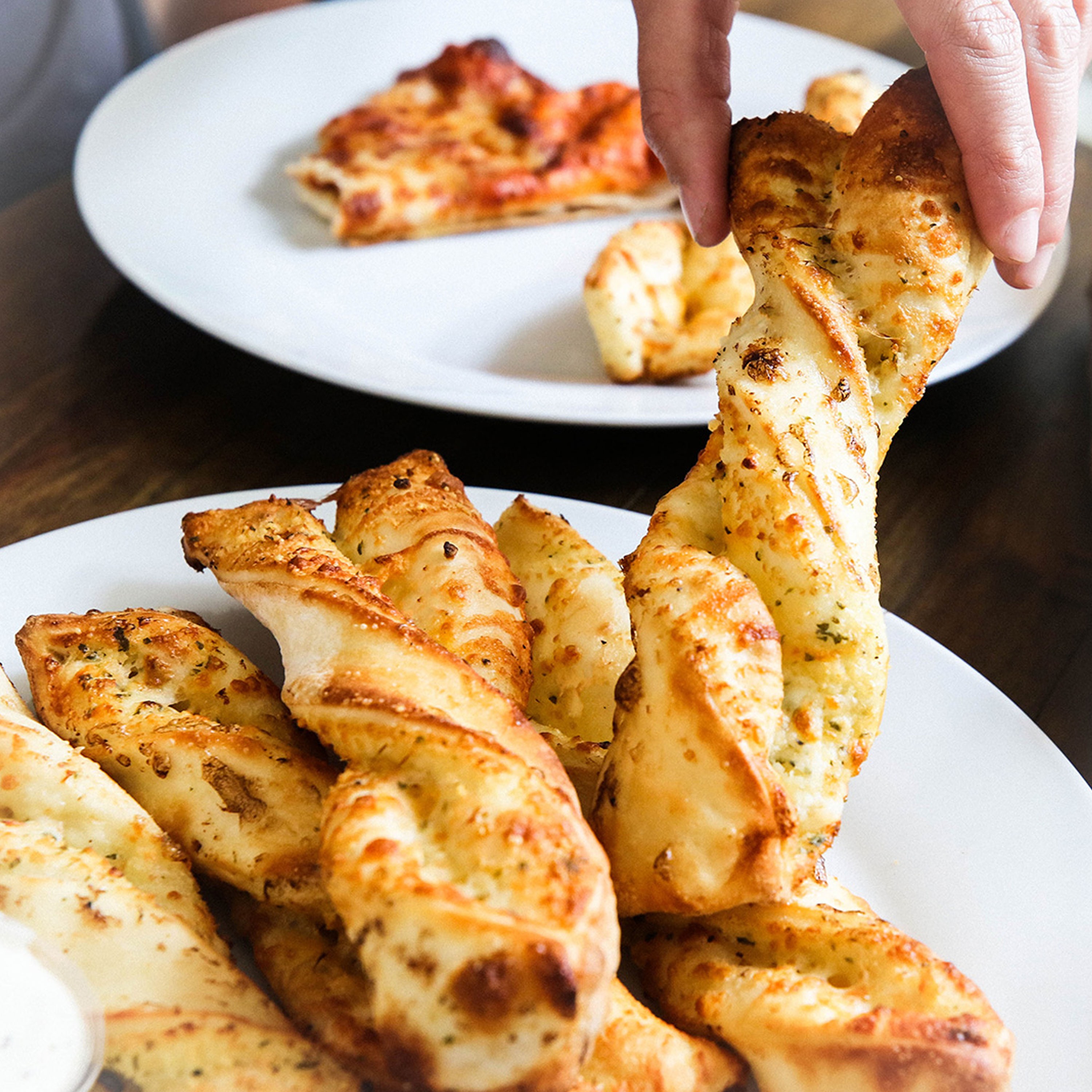 Order Garlic Parmesan Twists food online from Round Table Pizza store, Silverdale on bringmethat.com