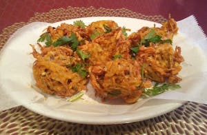 Order 9. Vegetable Pakora (7pcs) food online from New Taj Mahal Indian Restaurant store, Columbus on bringmethat.com
