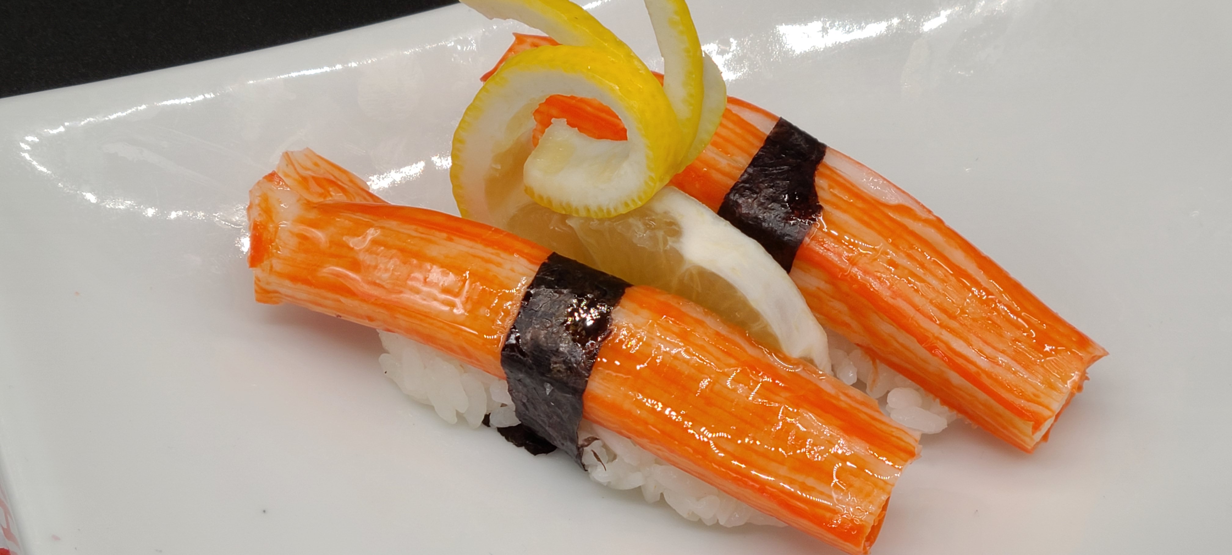 Order N9. Crab Stick Sushi(2pcs) food online from Hello Sushi store, Fullerton on bringmethat.com