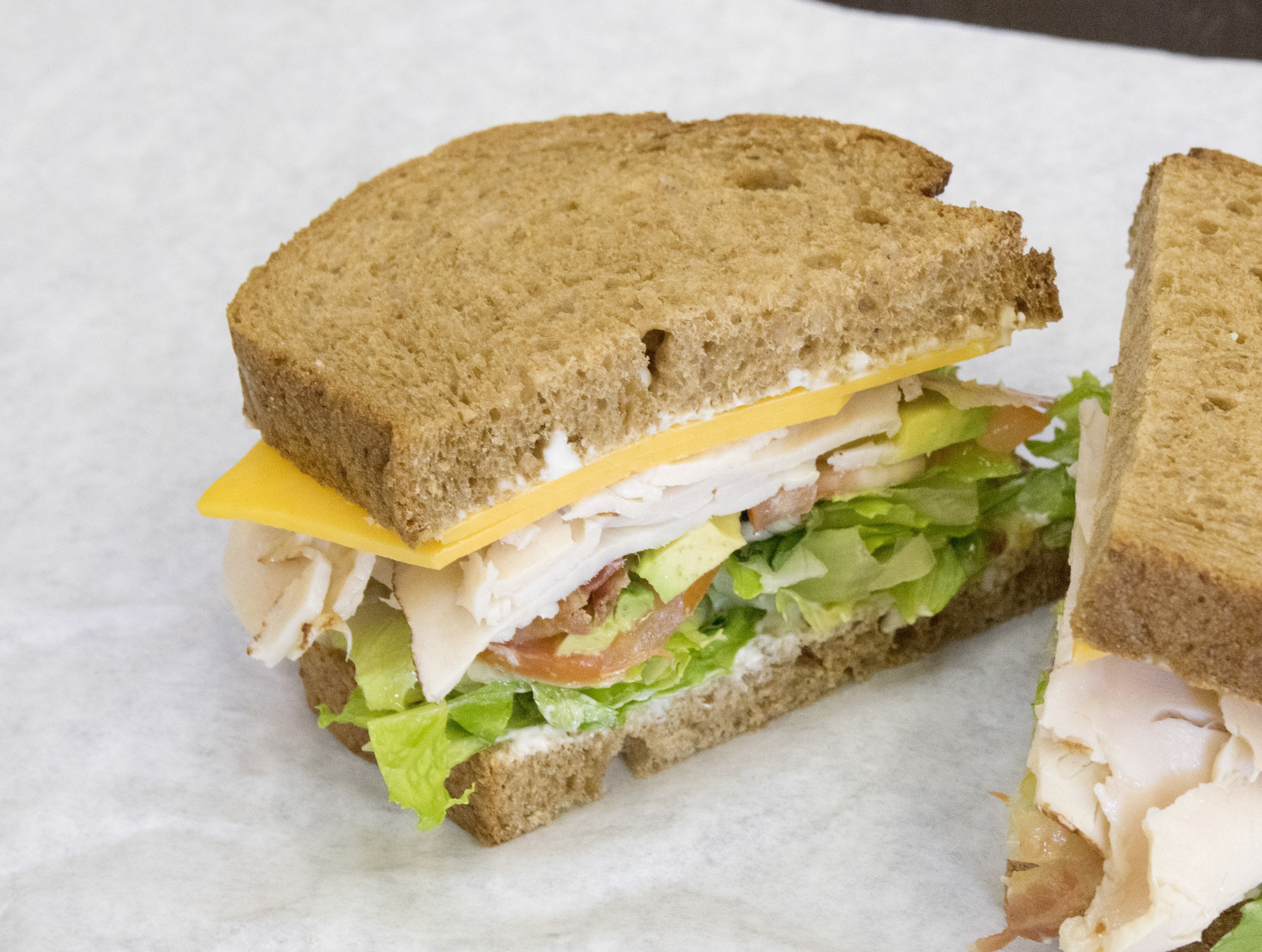 Order 8" California Club Sandwich food online from Knockout Deli store, San Diego on bringmethat.com