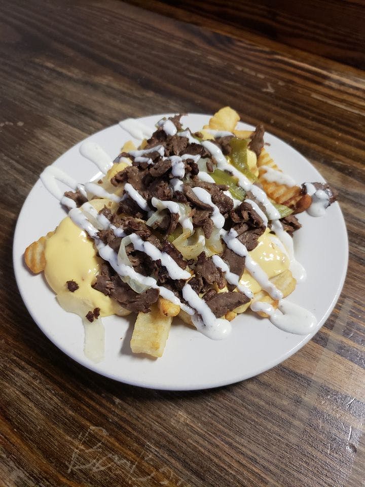 Order Philly Steak Fries - Appetizer food online from Hometown Pizza Cafe store, Water Valley on bringmethat.com