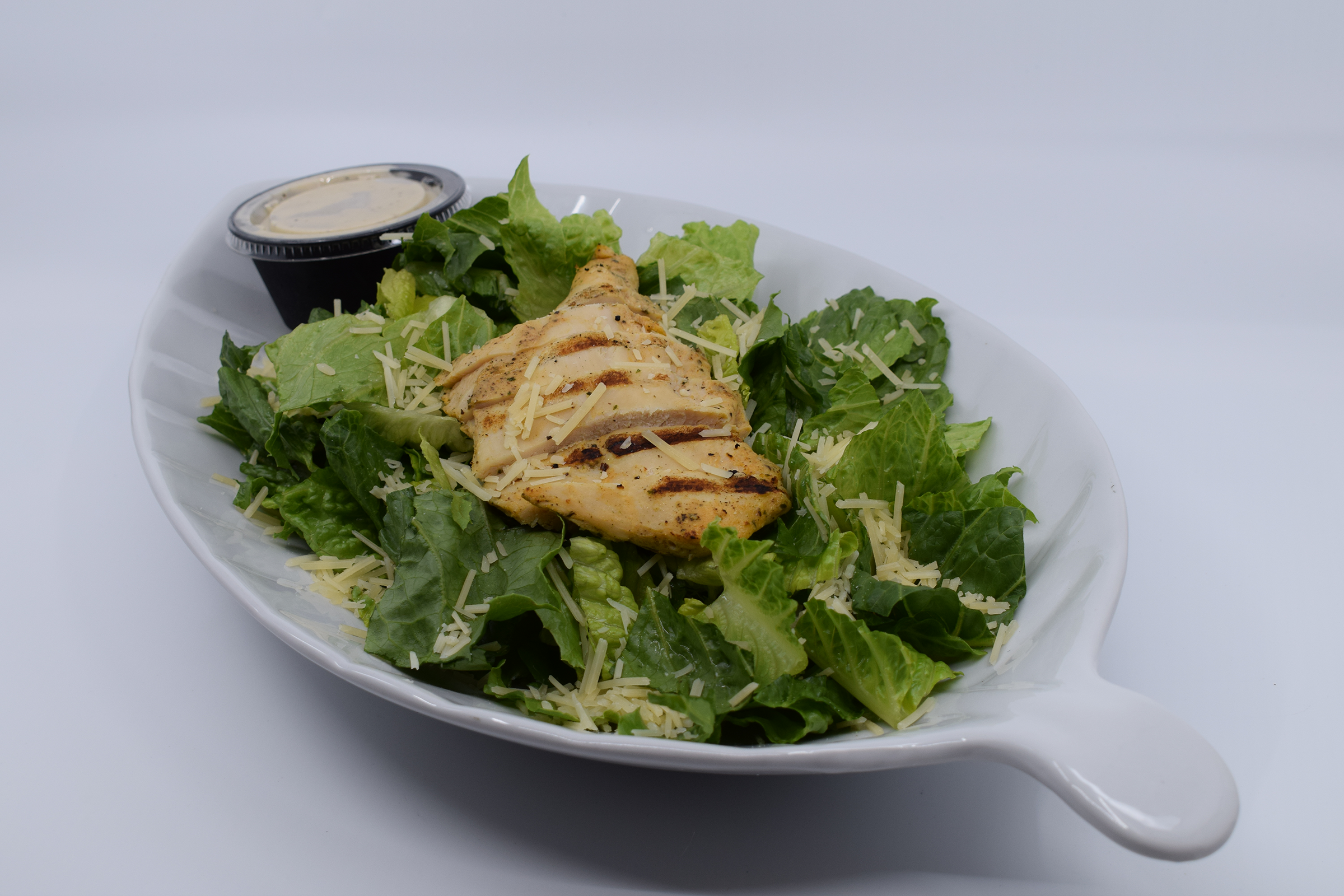 Order CHICKEN CAESAR SALAD food online from Mad House Comedy Club store, San Diego on bringmethat.com