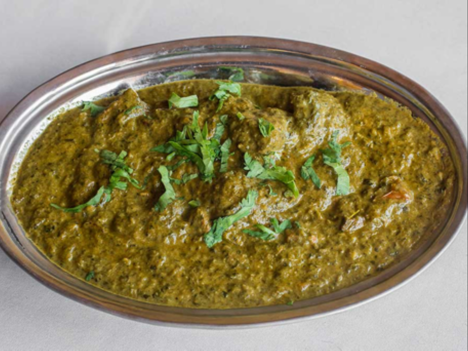 Order Lamb Saag food online from Passage to India store, Cambridge on bringmethat.com