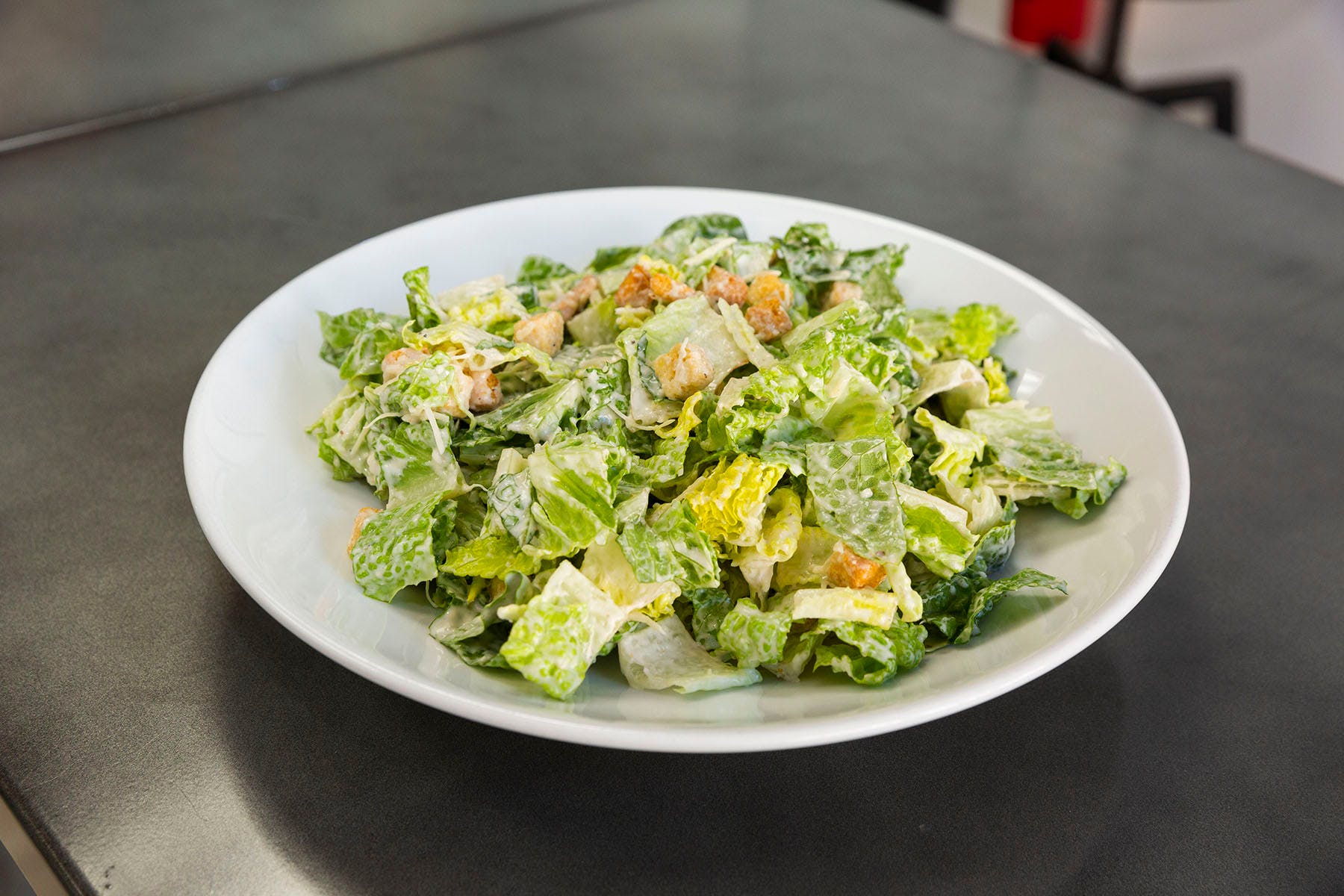 Order Caesar Salad - Salads food online from College Pizza store, Boston on bringmethat.com