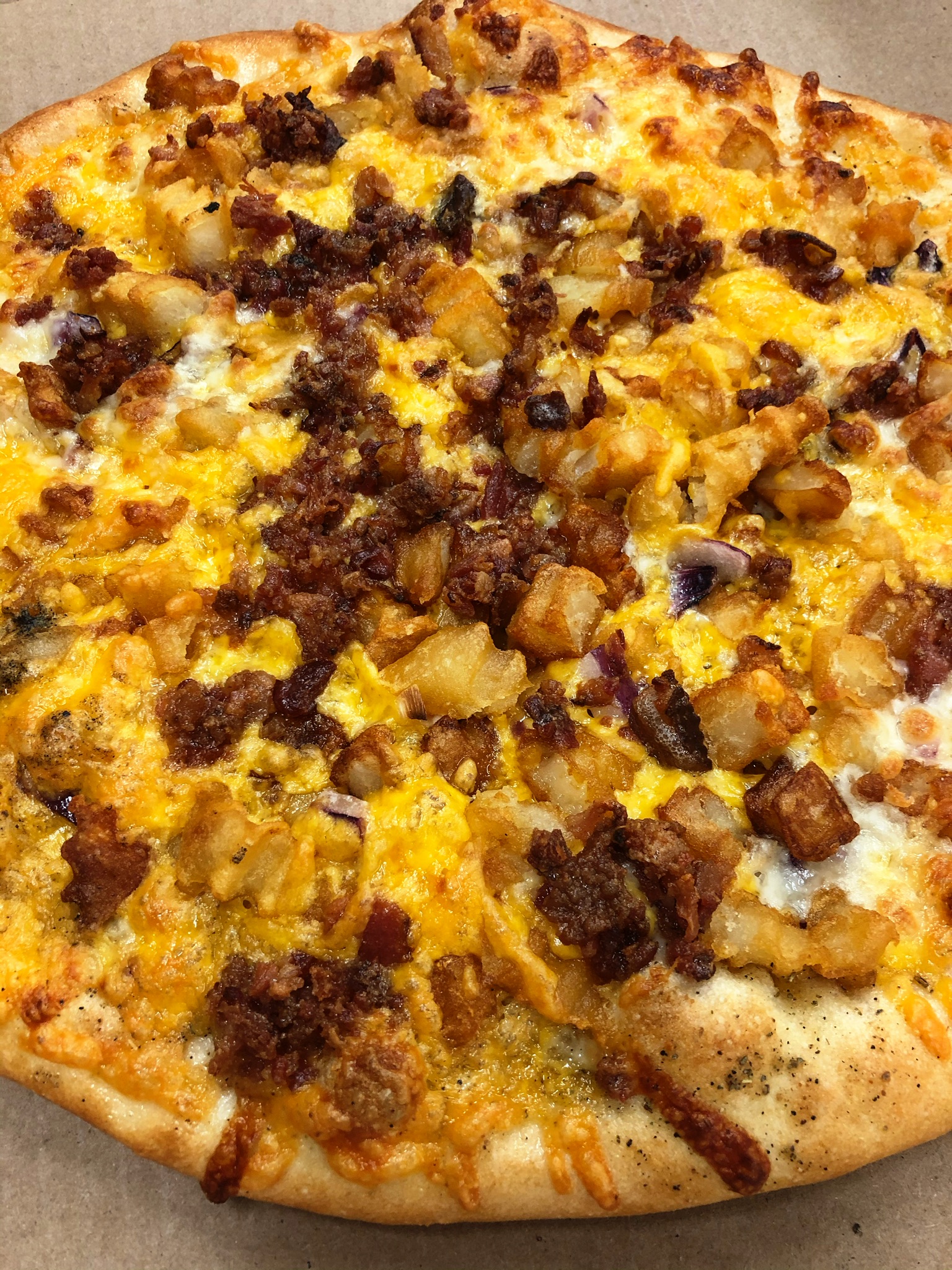 Order Loaded potato pizza food online from Rhino's Pizzeria store, Webster on bringmethat.com