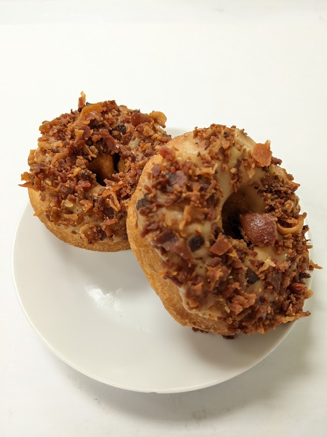 Order Yellow Cake Donut with Maple Frosting and Bacon  food online from Morkes Chocolate store, Huntley on bringmethat.com