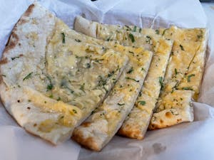 Order Garlic Cheese Naan food online from Crown of India store, Los Angeles on bringmethat.com