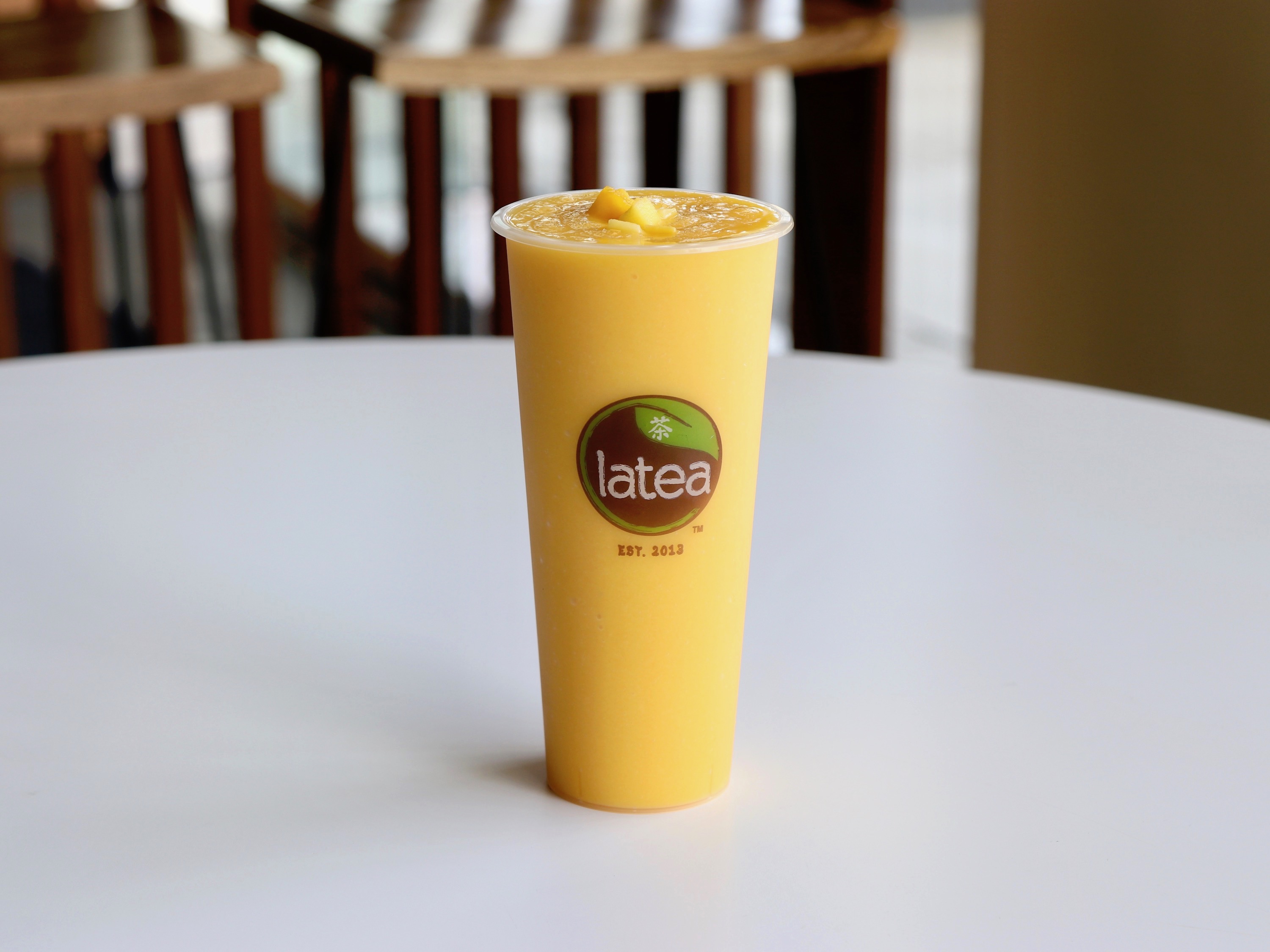 Order *Mango Smoothie food online from Latea Bubble Tea Lounge store, West Lafayette on bringmethat.com