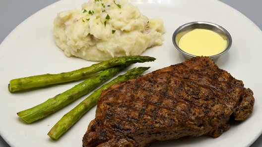 Order New York Strip 14 oz food online from Mitchell's Fish Market store, Louisville on bringmethat.com