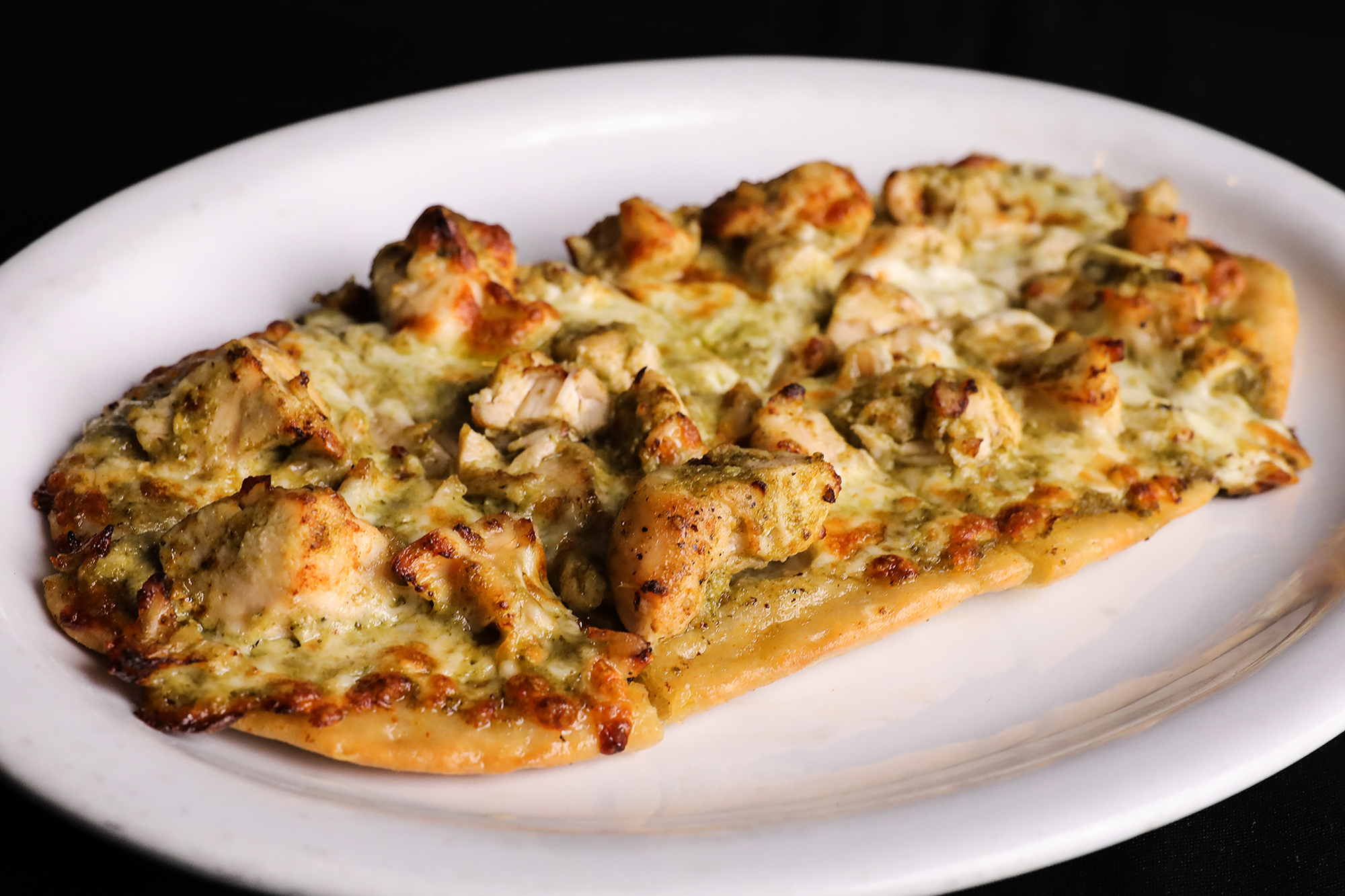 Order Chicken Pesto Flatbread Pizza food online from Port Restaurant & Bar store, Corona Del Mar on bringmethat.com
