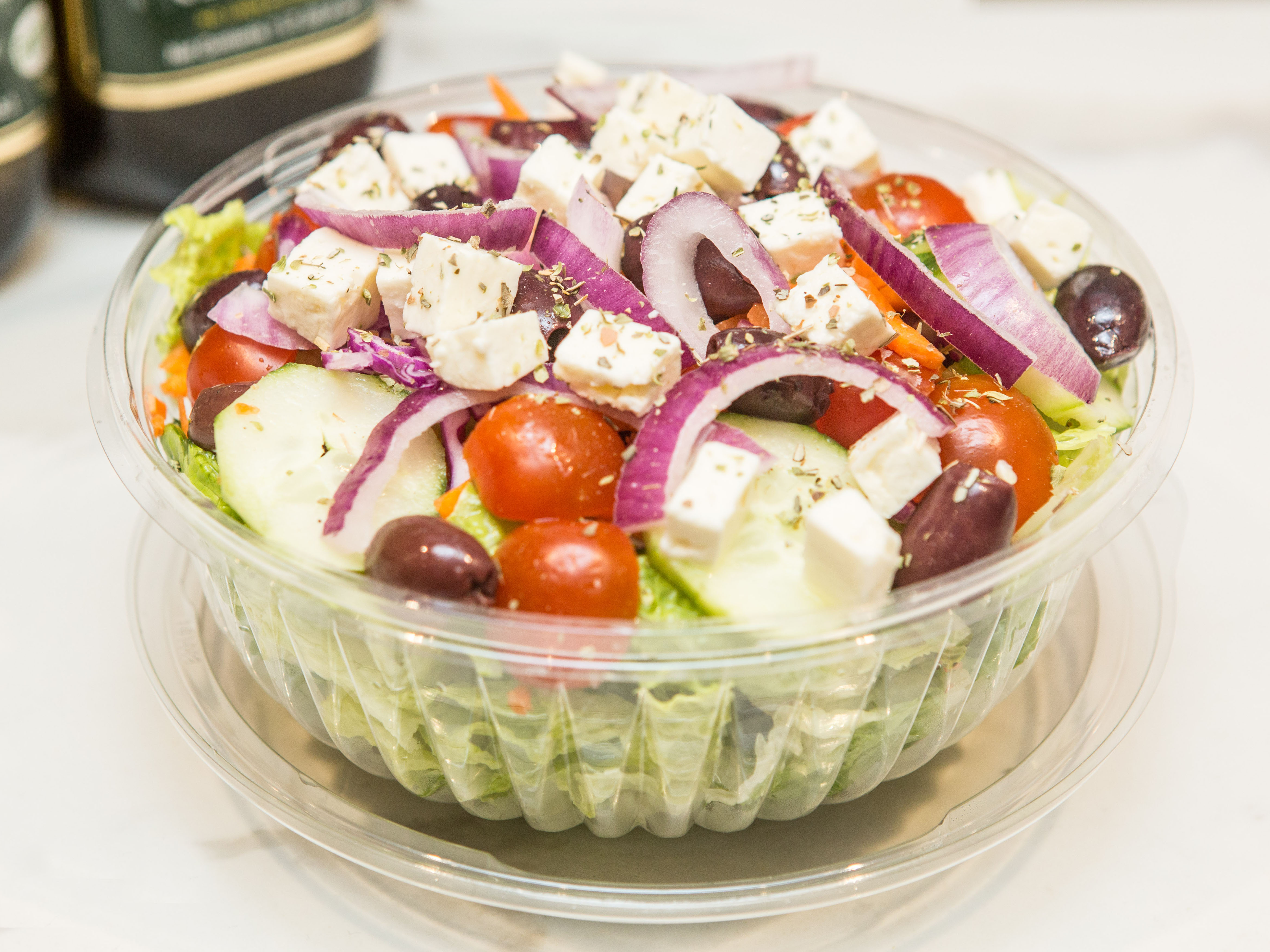 Order Greek Salad food online from Famous Famiglia Pizza store, New York on bringmethat.com