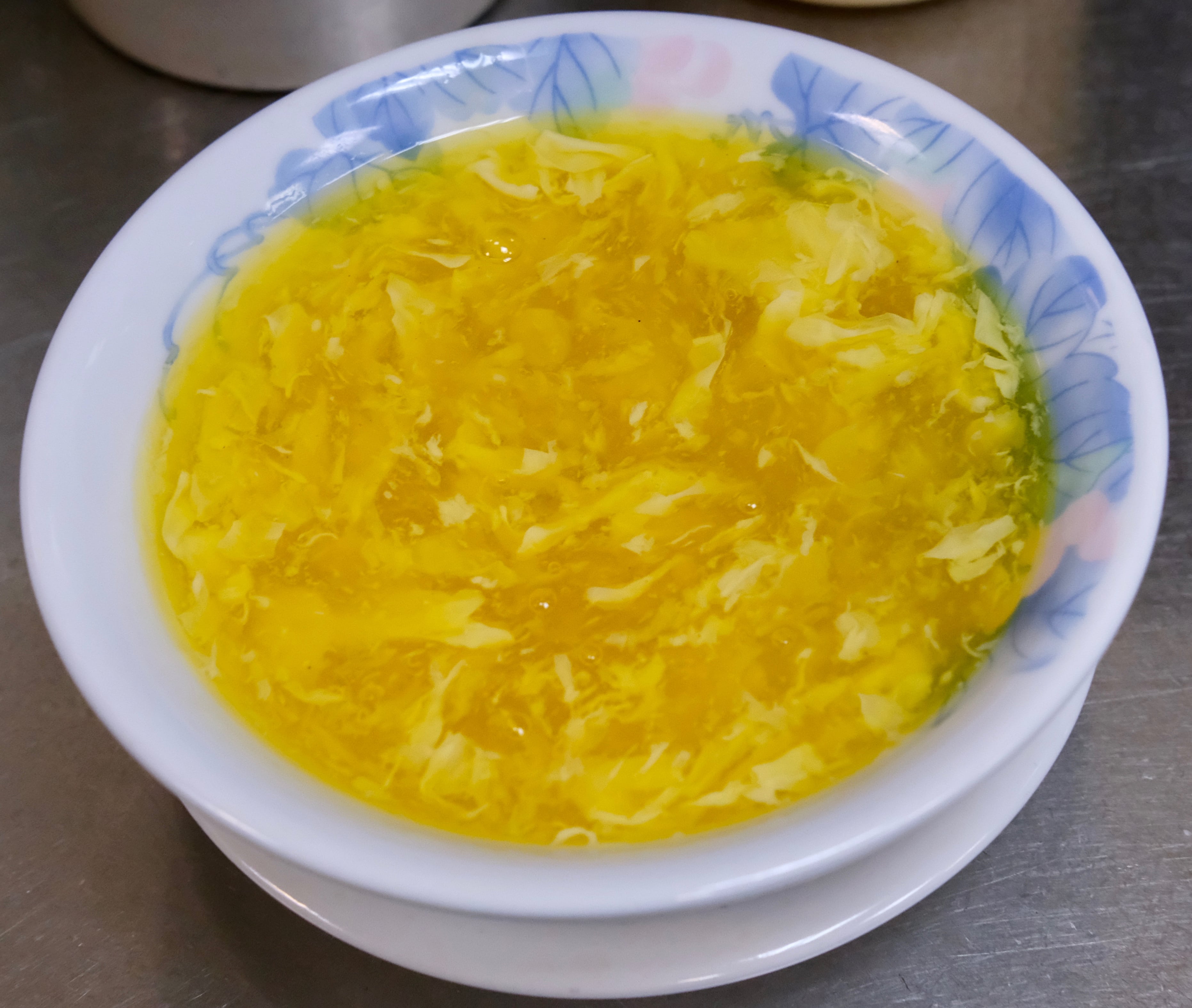 Order S3. Egg Drop Soup with Corn food online from Ollie's Noodle Shop & Grille store, New York on bringmethat.com