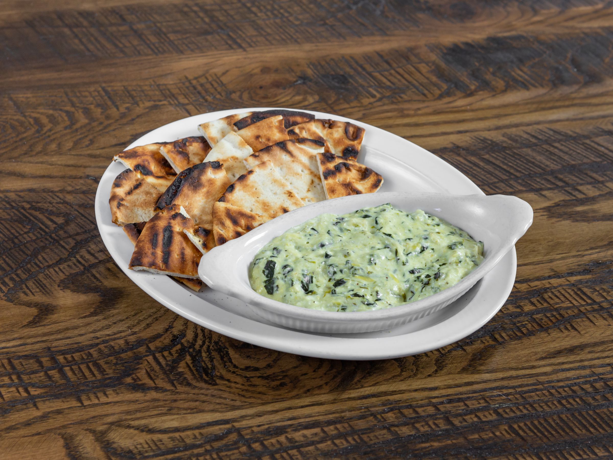Order Spinach Artichoke Dip with Pita Chips food online from Beacon Tavern & Grill store, Racine on bringmethat.com