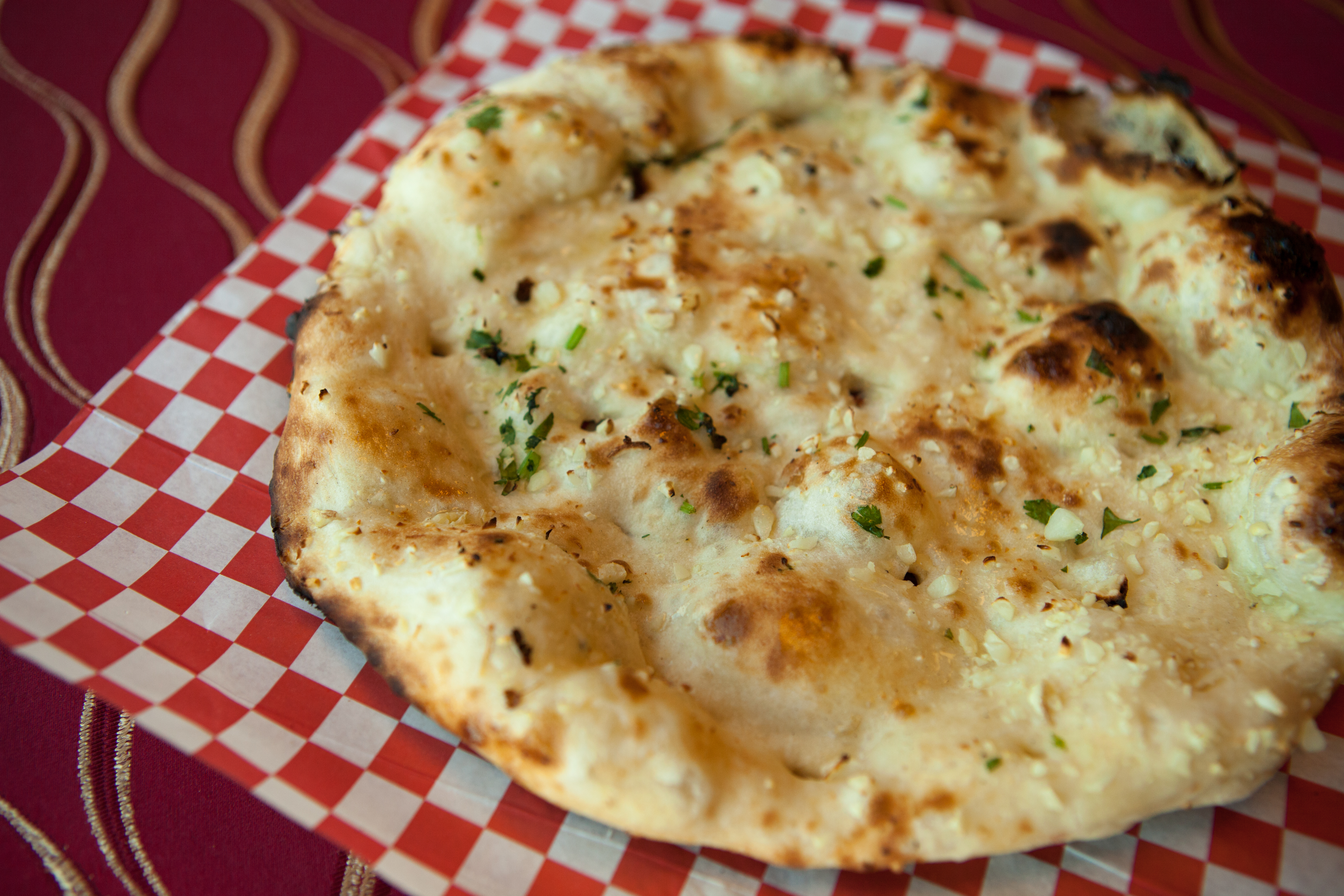 Order Garlic Naan food online from BBQ N Curry House store, Sausalito on bringmethat.com