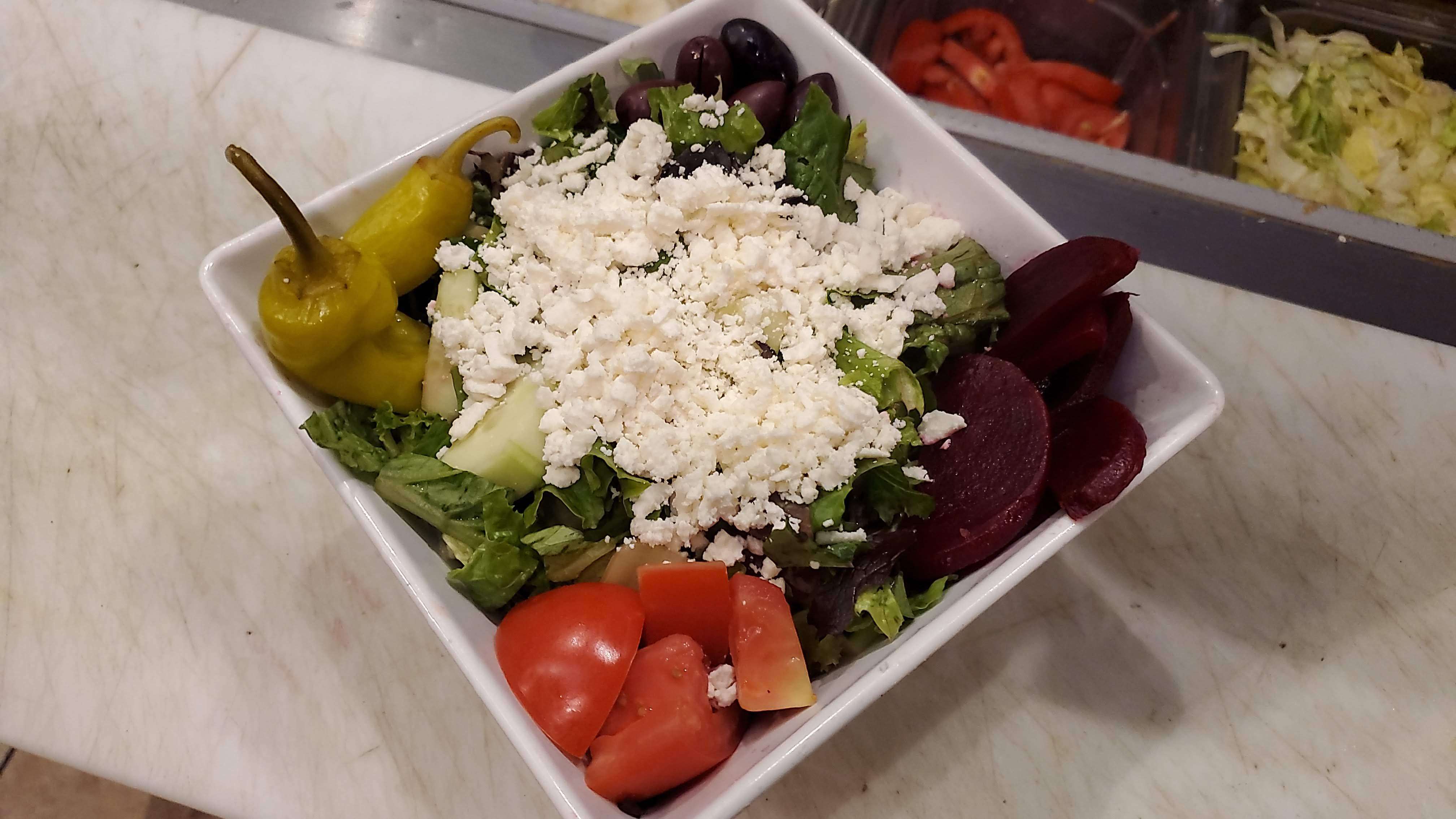 Order LG Greek Salad food online from Phoenicia Cafe store, Gilbert on bringmethat.com