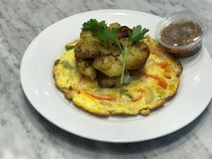 Order FRITATTA ITALIANO: Eggs, Bell Peppers, Onions, Potatoes, Cheese food online from Milano Cafe & Deli store, Burbank on bringmethat.com