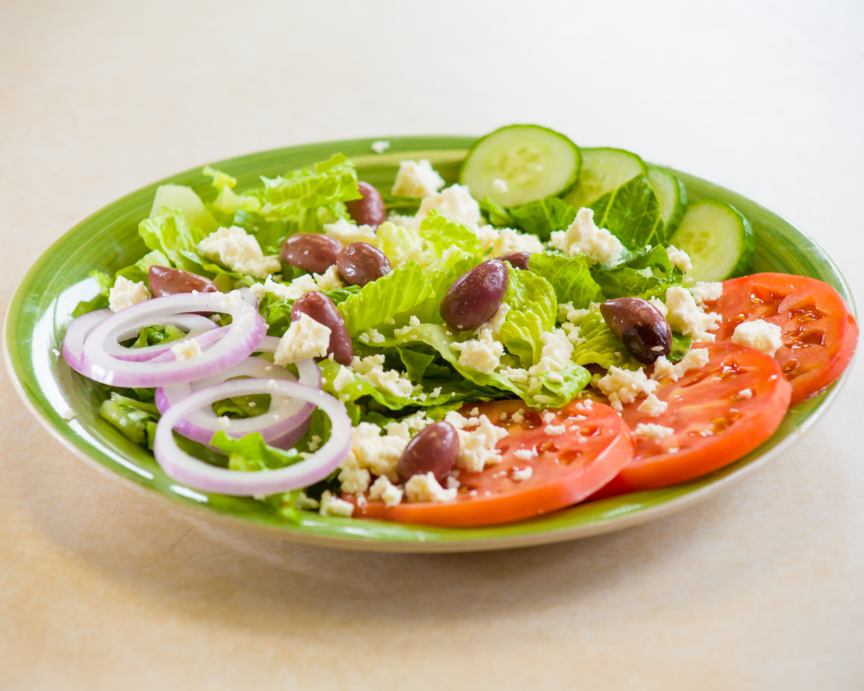 Order Greek Salad food online from Gaya Pizzeria store, Somerville on bringmethat.com