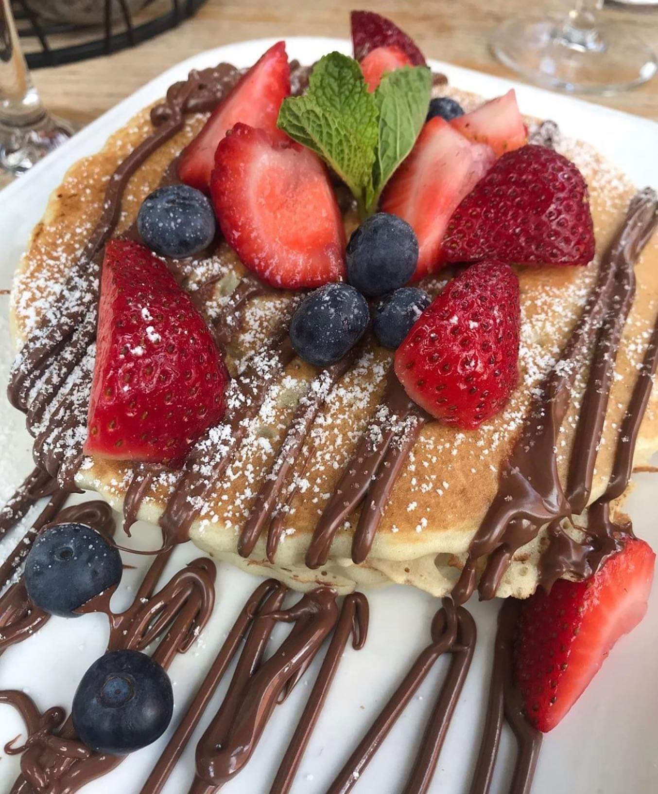 Order BERRY NUTELLA PANCAKES. food online from Gramercy Kitchen store, New York on bringmethat.com
