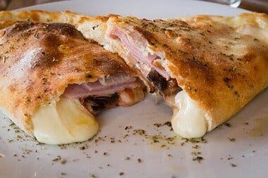 Order One Meat Calzone - Calzone food online from Emiliano's Pizza store, Poughkeepsie on bringmethat.com