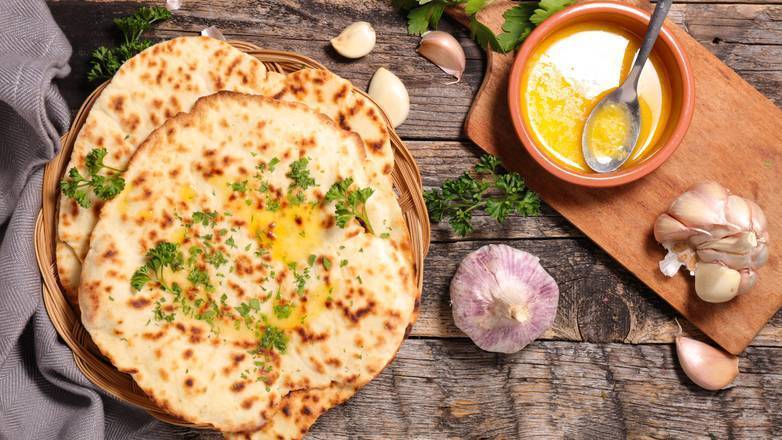 Order Garlic Naan (1pc) food online from Aroma Indian Restaurant store, Bloomington on bringmethat.com