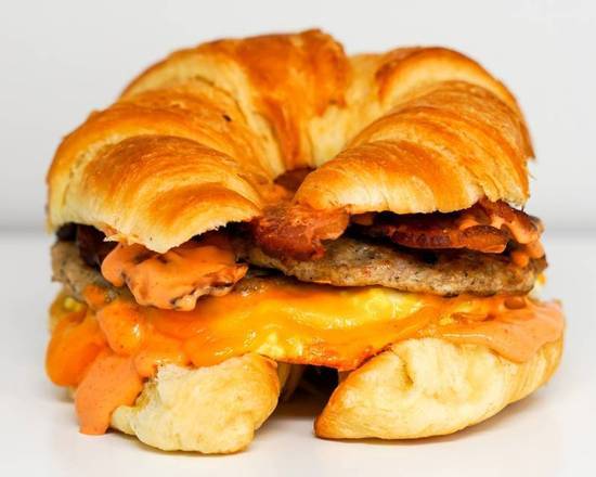 Order Croissant, Bacon, Sausage, Egg & Cheddar food online from Neighborhood Cafe store, Hopewell on bringmethat.com