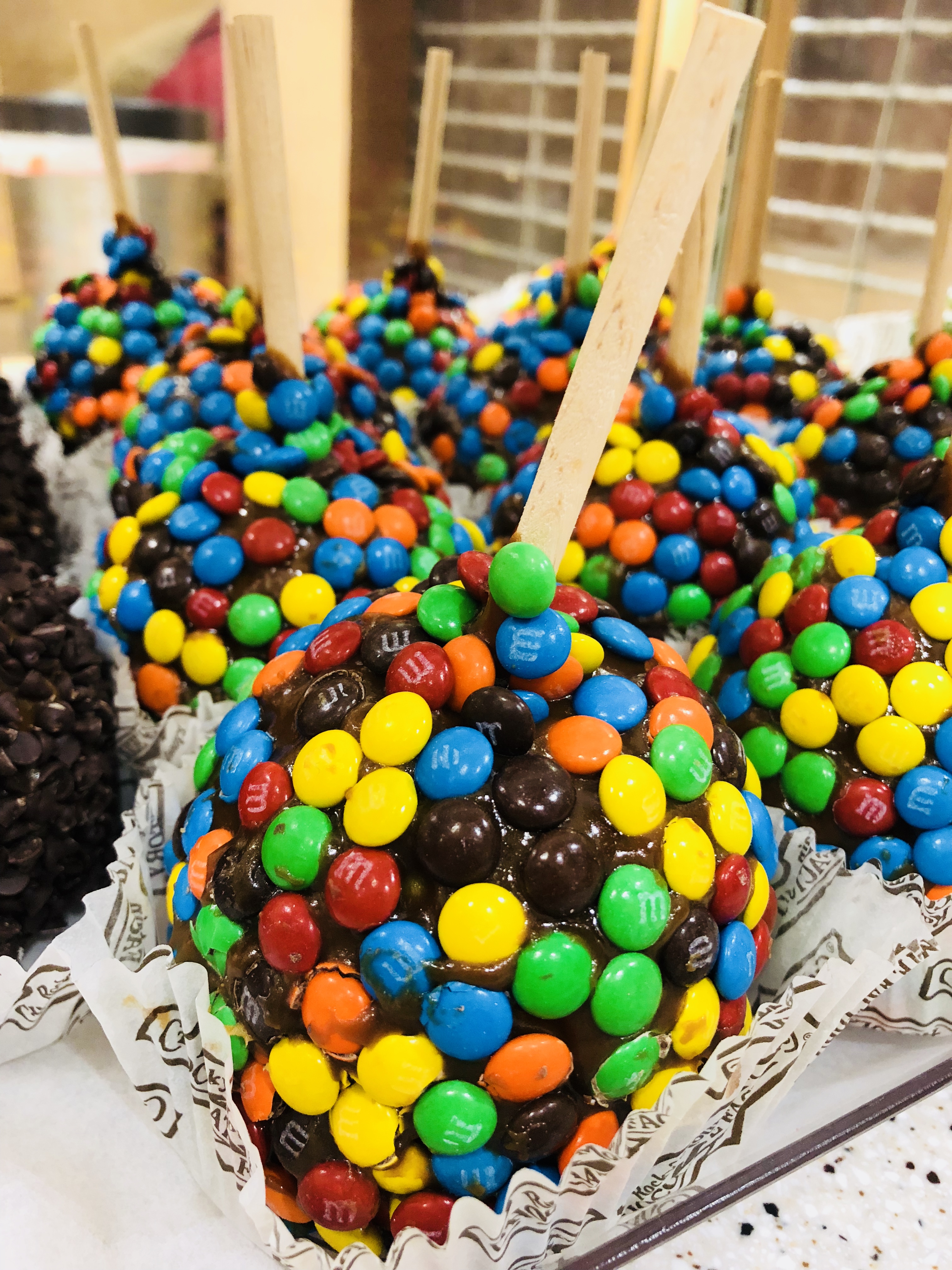 Order M&M Caramel Apple food online from Rocky Mountain Chocolate Factory store, Brea on bringmethat.com