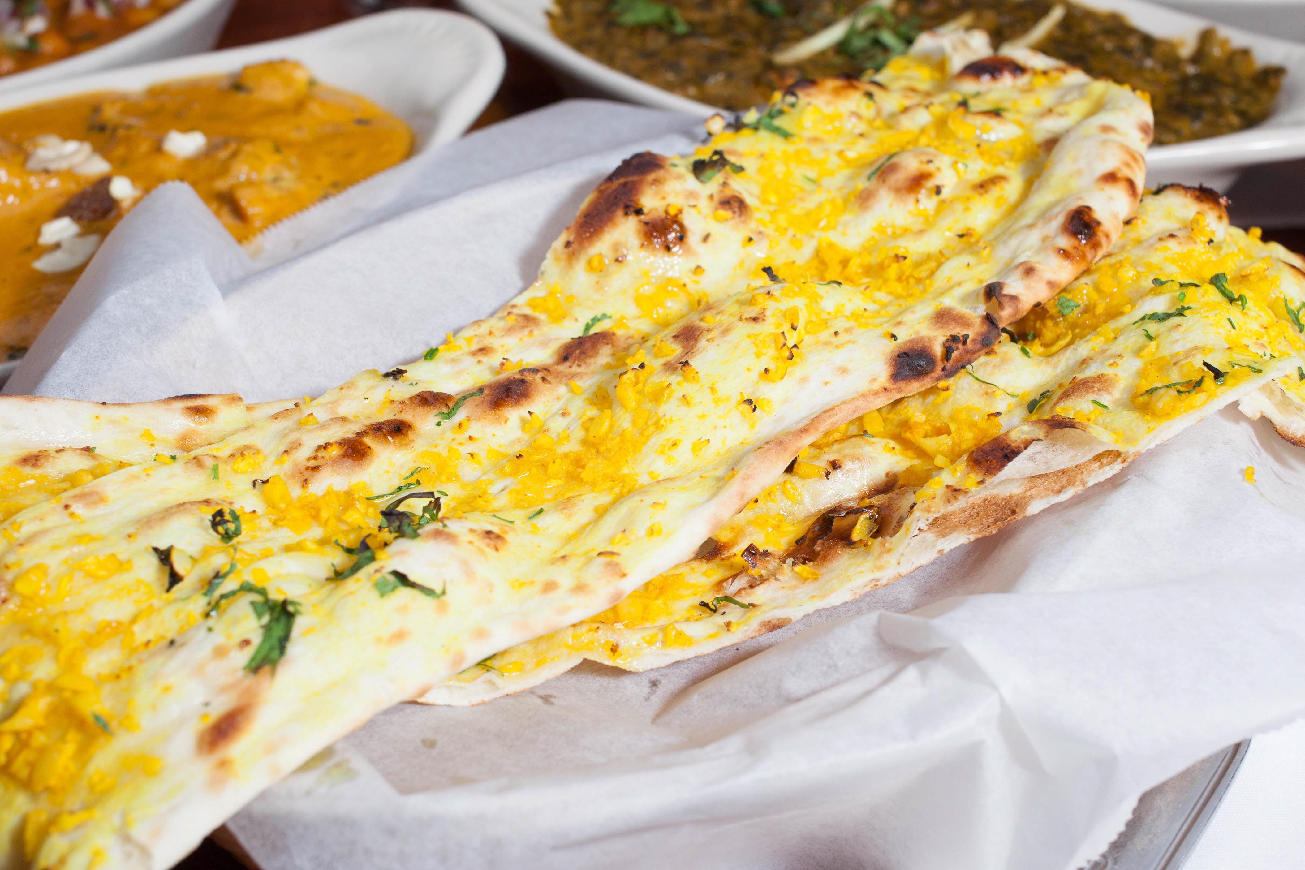 Order Garlic Naan food online from Mission Curry House store, San Francisco on bringmethat.com