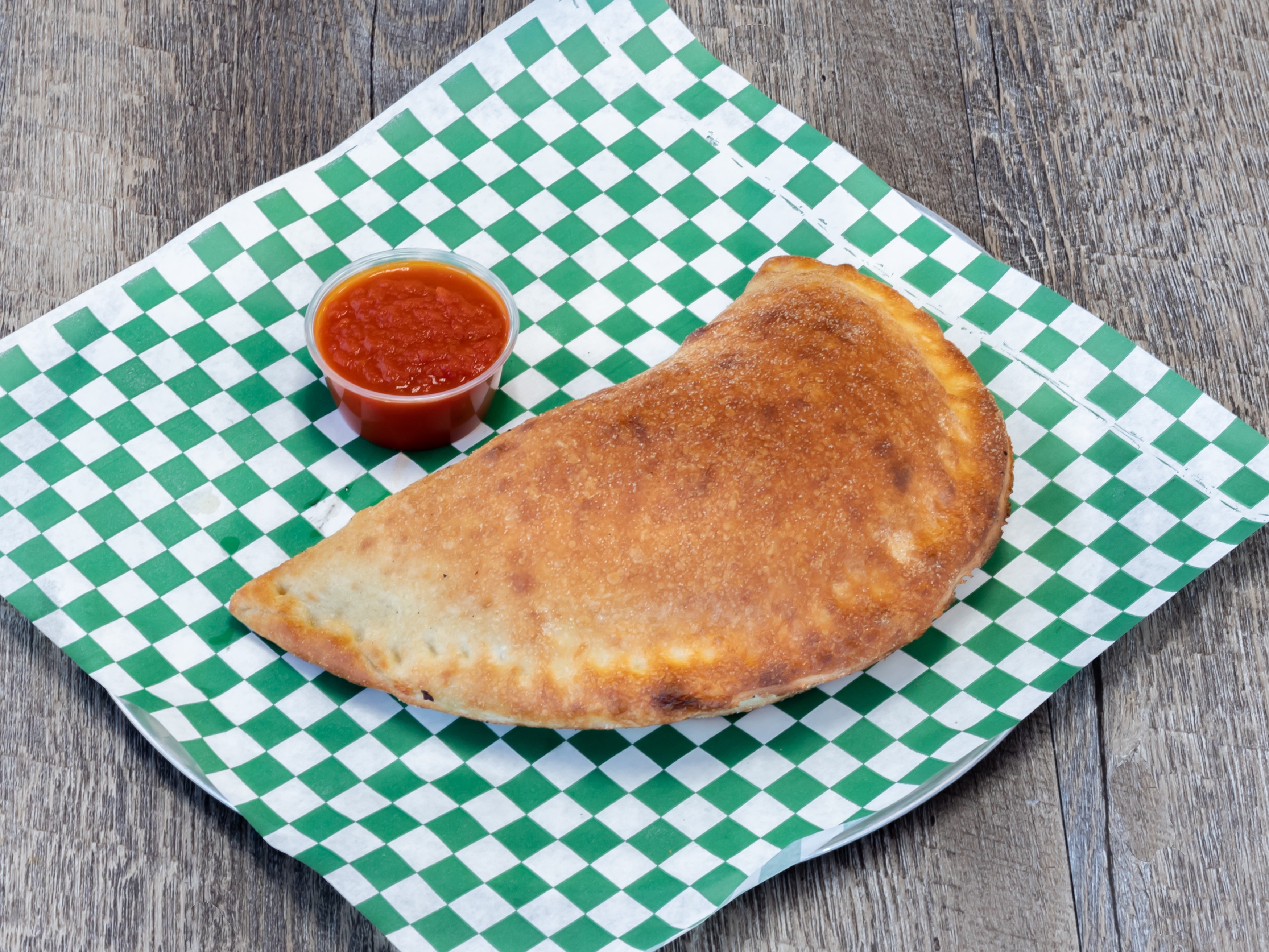 Order Meat Calzone food online from The Pasta Bar store, San Antonio on bringmethat.com