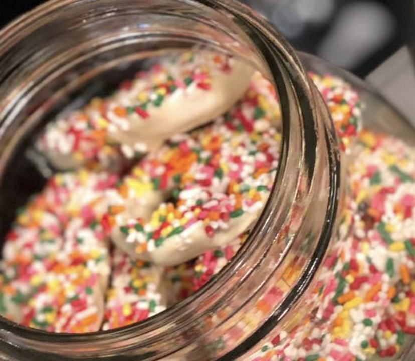 Order WHITE Chocolate Covered Sprinkles Pretzel food online from The Sweet Shop Nyc store, New York on bringmethat.com