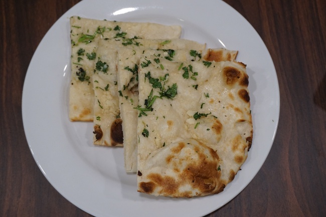 Order Garlic Naan. food online from The Madras Cafe store, Aurora on bringmethat.com