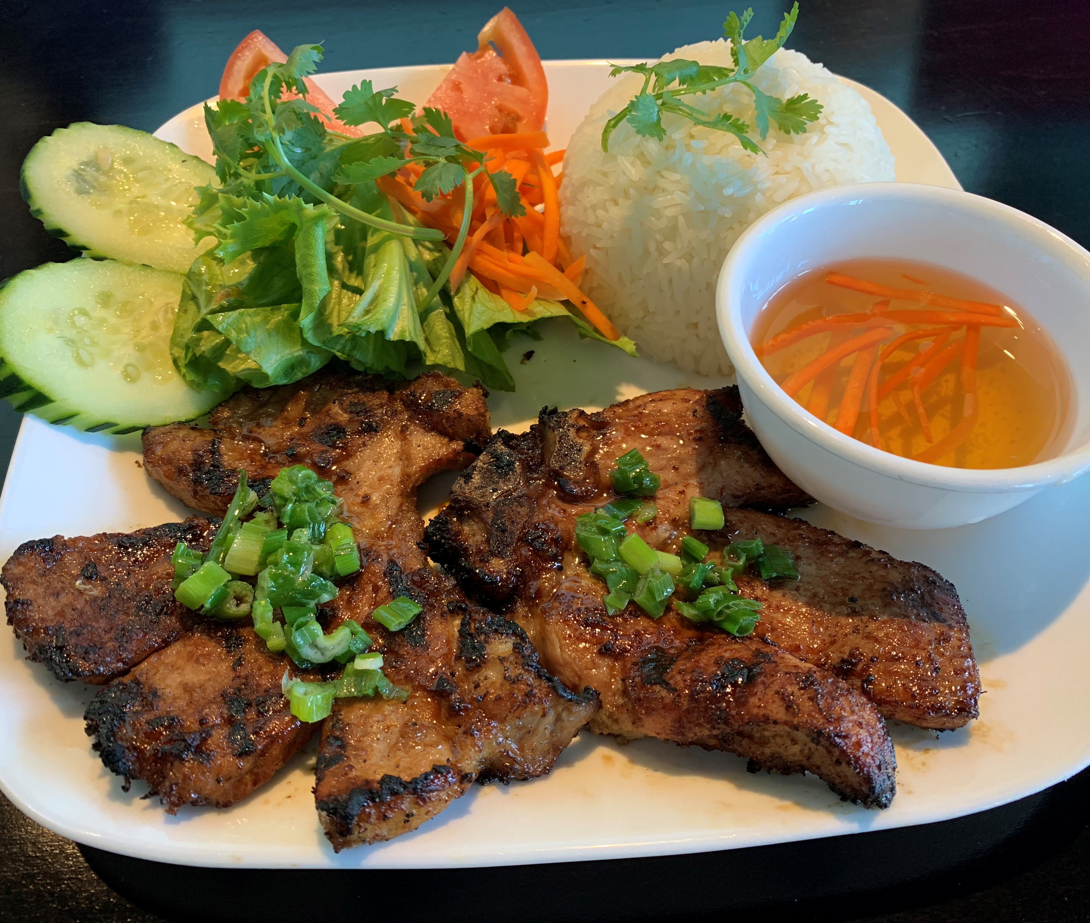 Order R8. CharBroiled Pork Chop Over White Rice food online from Pho Amour store, Fontana on bringmethat.com