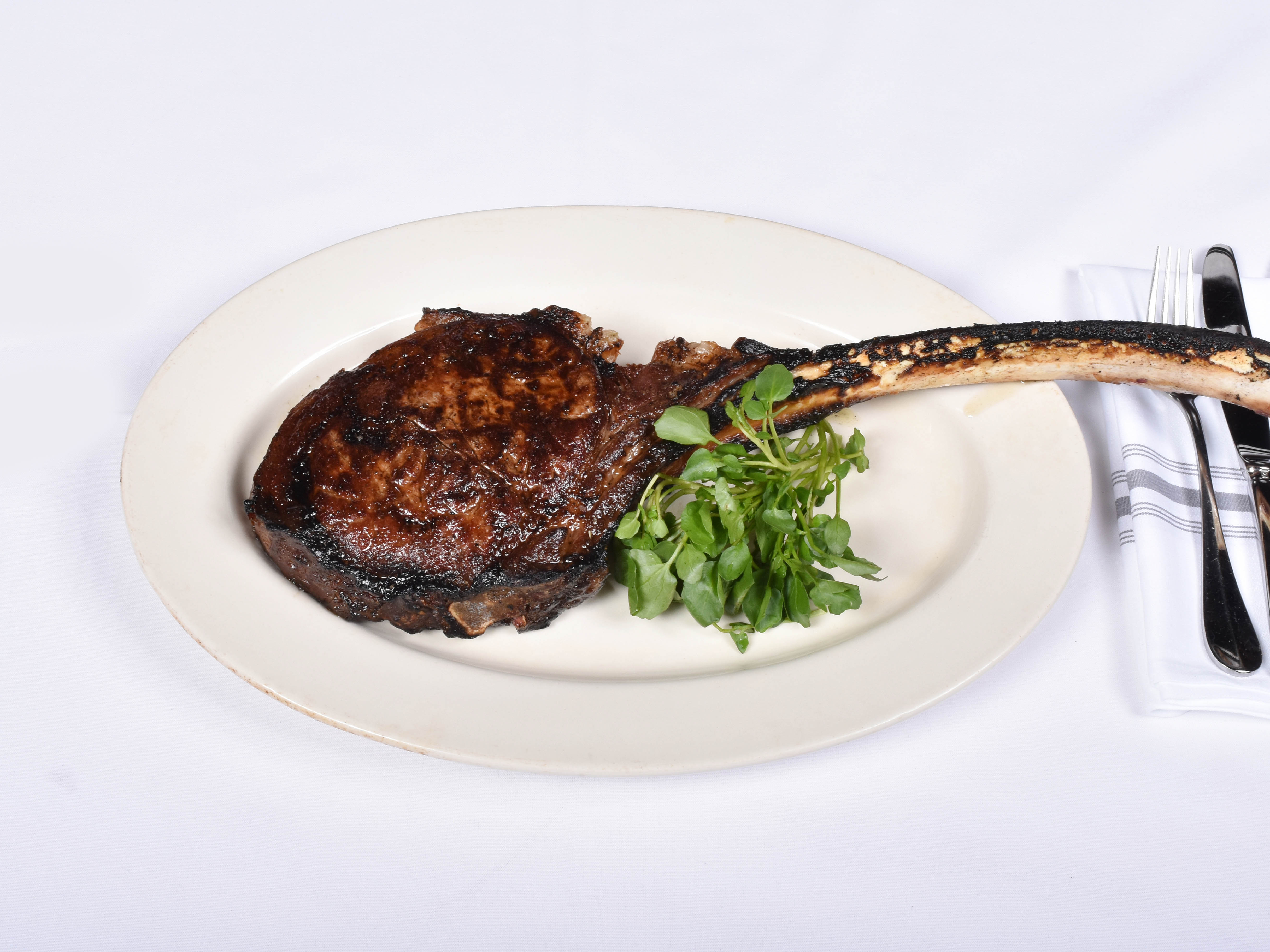 Order Bone in Ribeye Steak for 1 food online from Blackstones Grille store, Southport on bringmethat.com