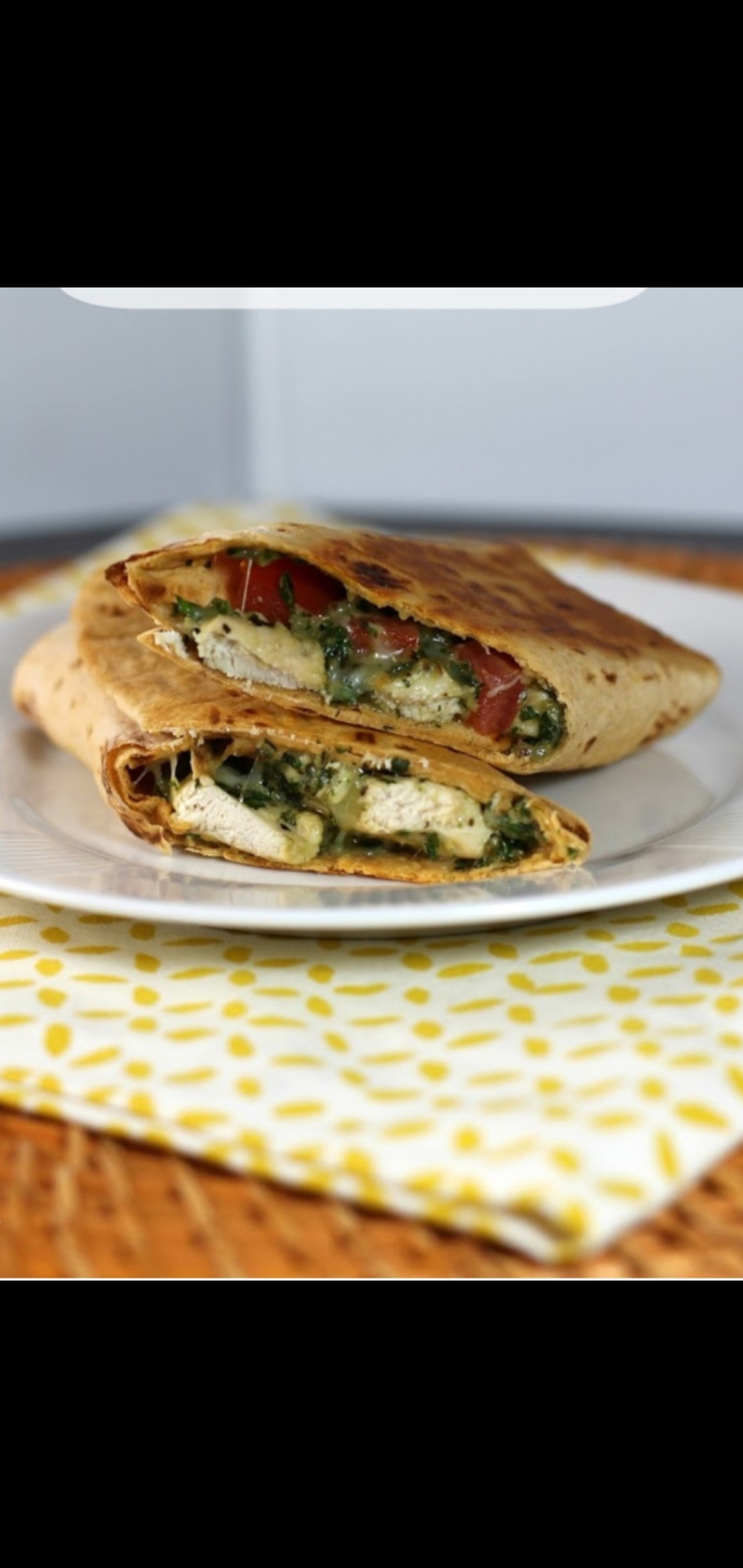 Order Italian Pesto Wrap (grilled chicken fresh mozzarella parmesan cheese peppers onions tomatoes & Pesto Sauce) food online from American Gourmet Foods Deli store, New York on bringmethat.com
