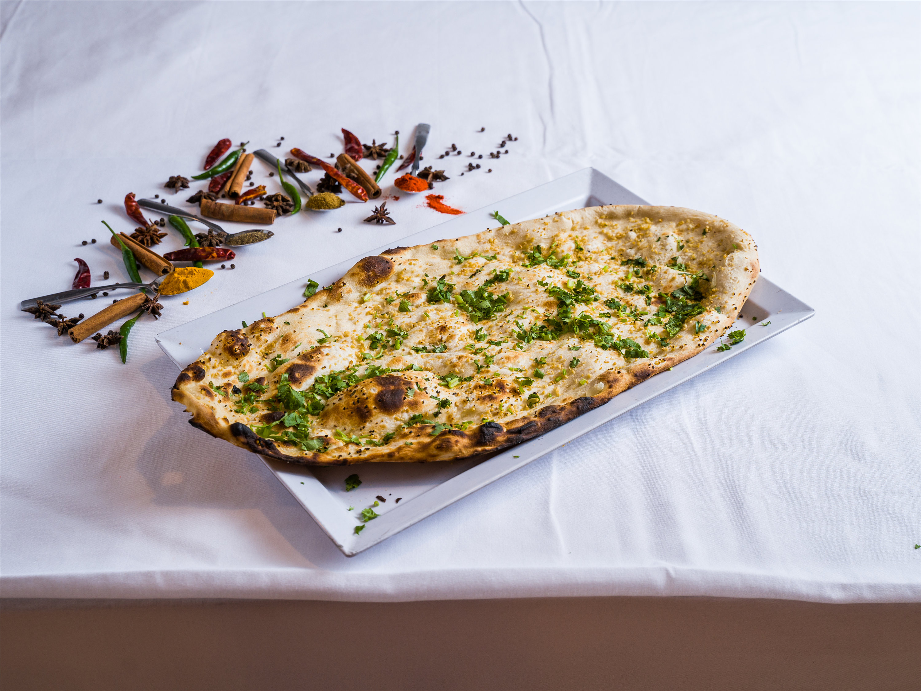 Order Garlic Naan food online from The Cotillion store, Jericho on bringmethat.com