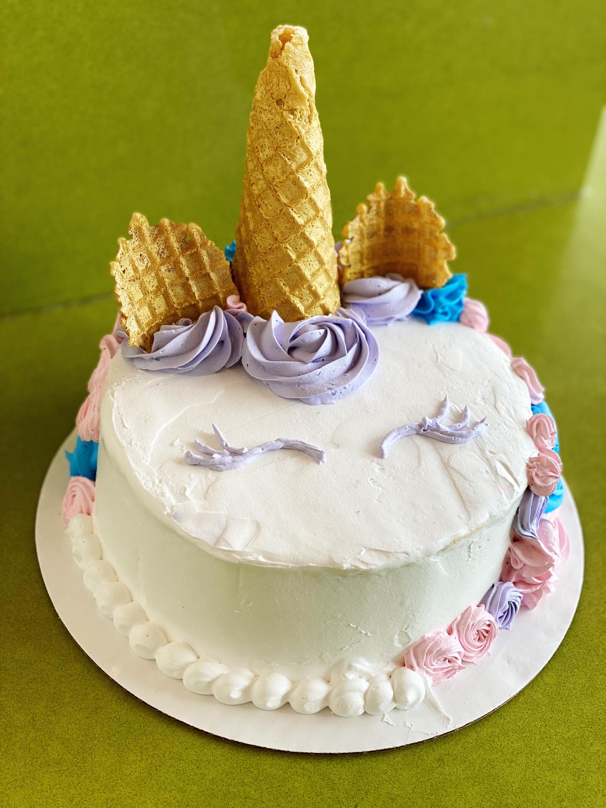 Order Unicorn Cake (8" Family Size serves 8-10) food online from Menchie's store, El Paso on bringmethat.com