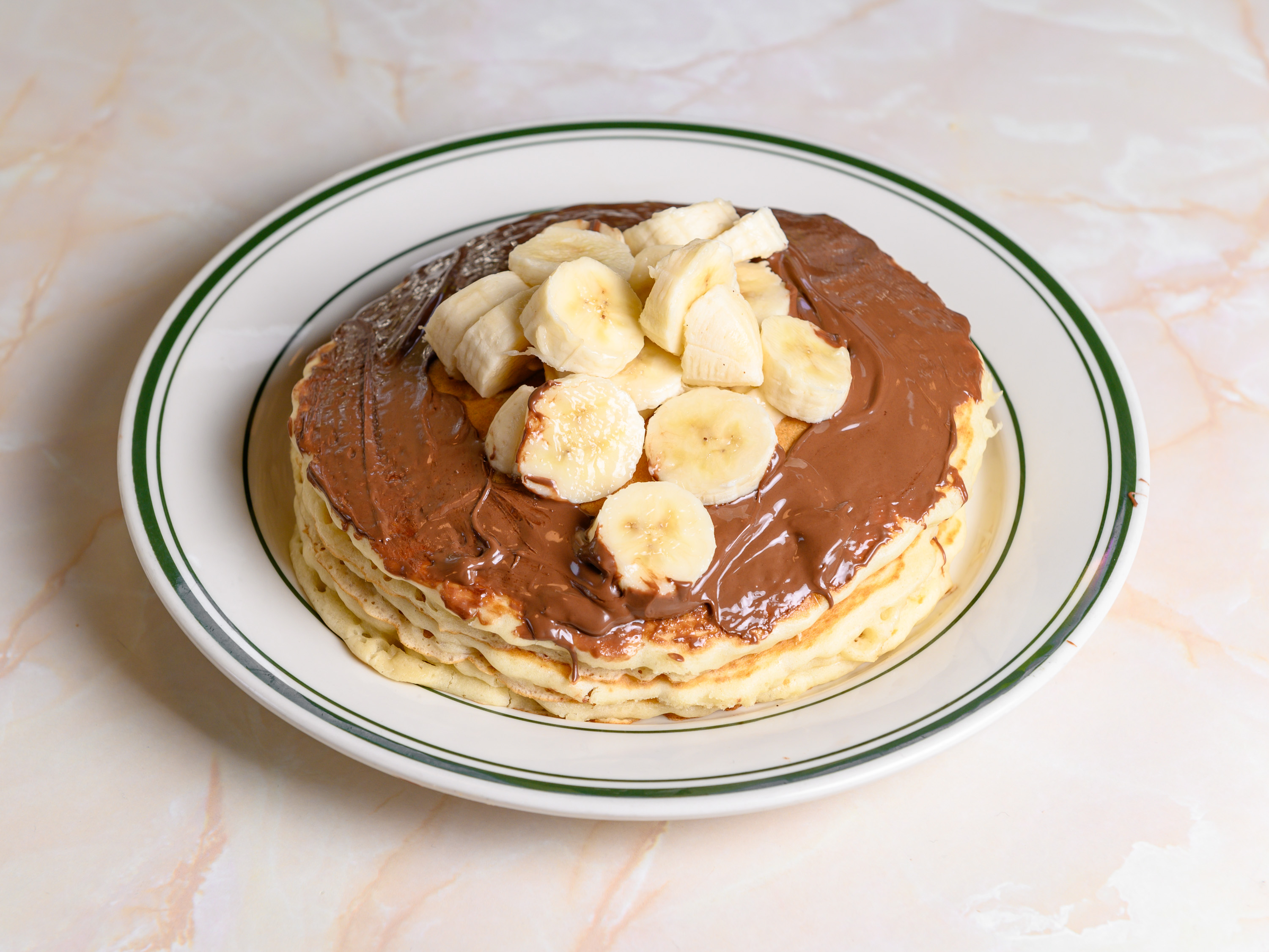 Order Banana Nutella Pancake food online from Ritz Diner store, New York on bringmethat.com